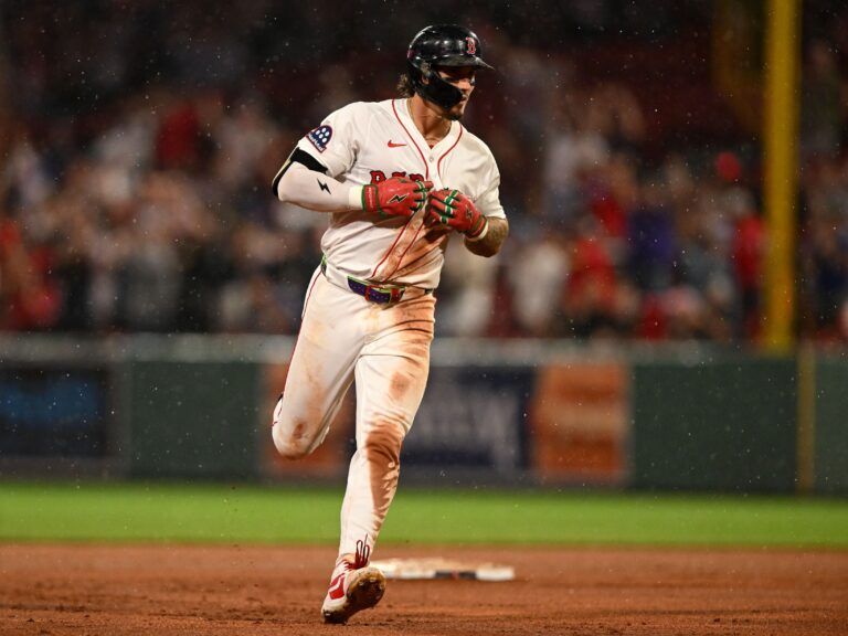 Boston Red Sox outfielder Jarren Duran (16) runs the bases after hitting a three-run home run against the Colorado Rockies during the eighth inning at Fenway Park.