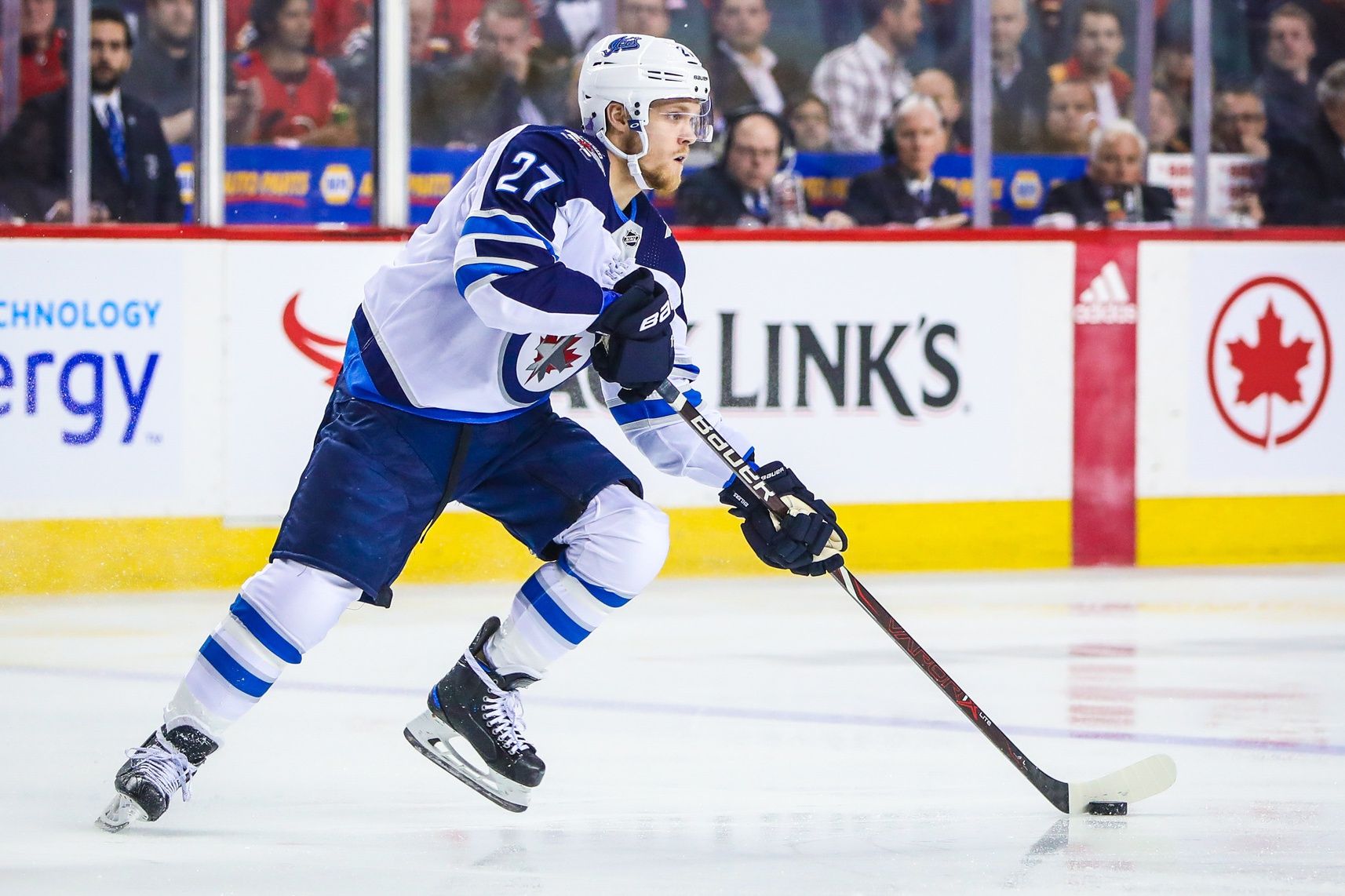 Winnipeg Jets left wing Nikolaj Ehlers (27) skates with the puck against the Calgary Flames during the first period at Scotiabank Saddledome.