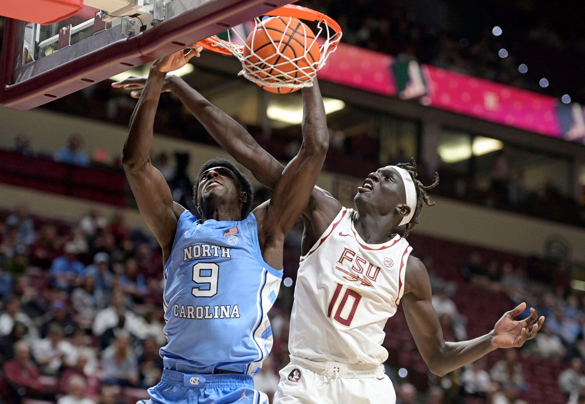 North Carolina Tarheels guard Drake Powell (9) dunks the ball over Florida State Seminoles forward Taylor Bol Bowen (10) during the second half at Donald L. Tucker Center.