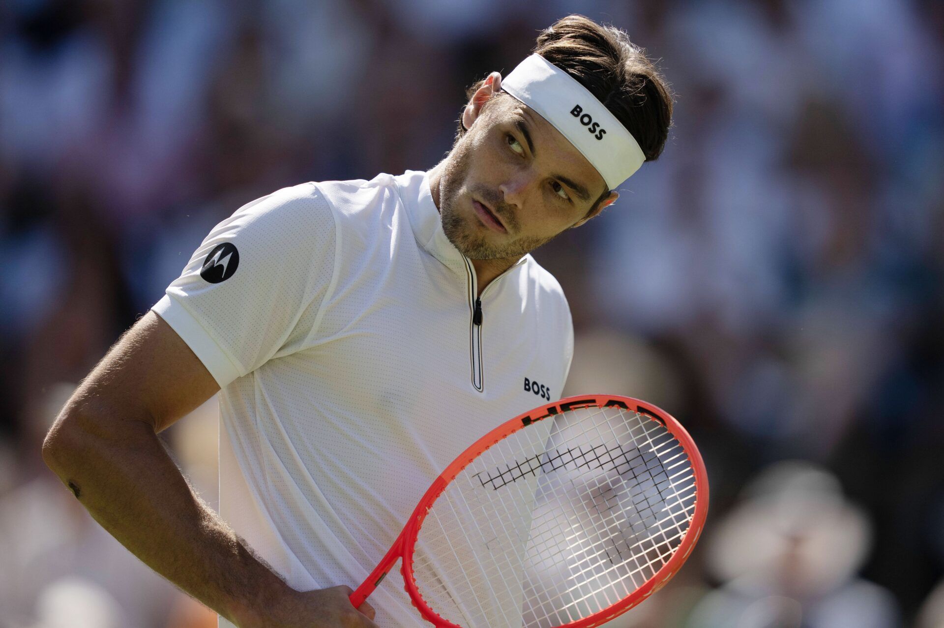 Taylor Fritz of the United States reacts to a  point during his match against Carlos Alcaraz of Spain on day 12 at All England Lawn Tennis and Croquet Club.