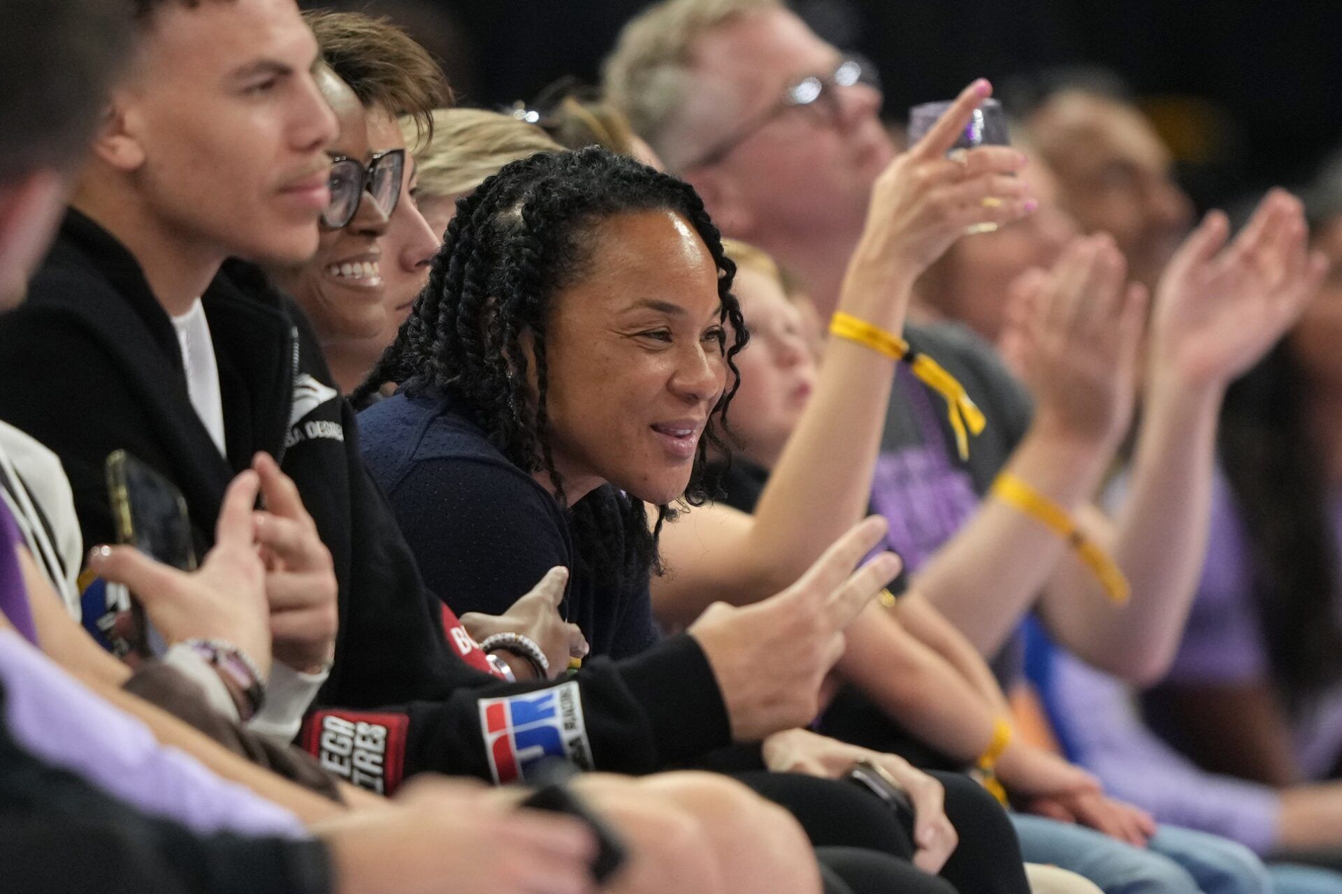 South Carolina Gamecocks women's basketball head coach Dawn Staley (center) sits courtside during the second quarter of the game between the Golden State Valkyries and the Seattle Storm at Chase Center.