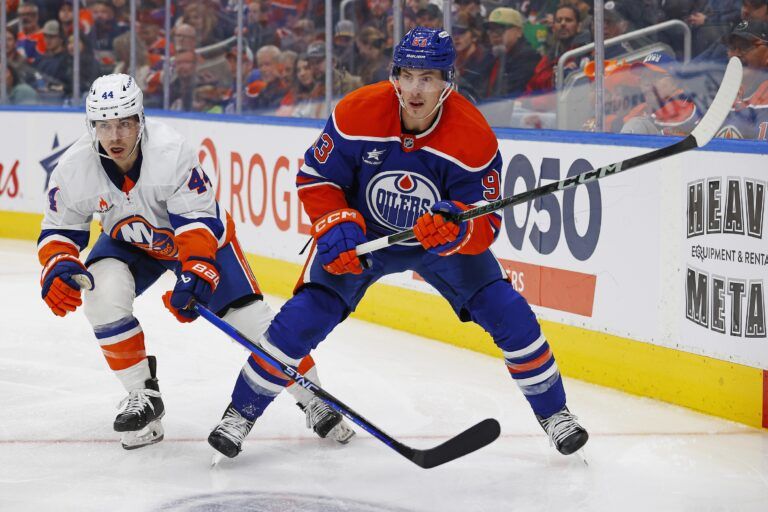 Edmonton Oilers forward Ryan Nugent-Hopkins (93) and New York Islanders forward Jean-Gabriel Pageau (44) look for a loose puck during the third period at Rogers Place.