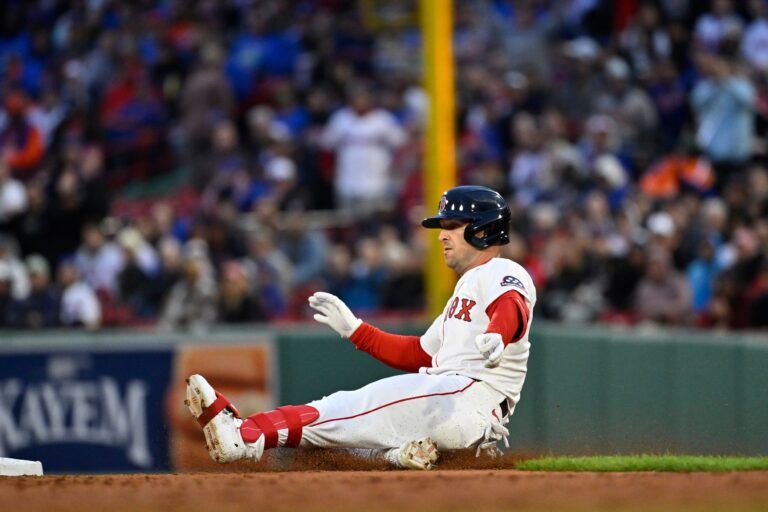 Boston Red Sox third baseman Alex Bregman (2) slides into second base during the third inning against the New York Mets at Fenway Park.