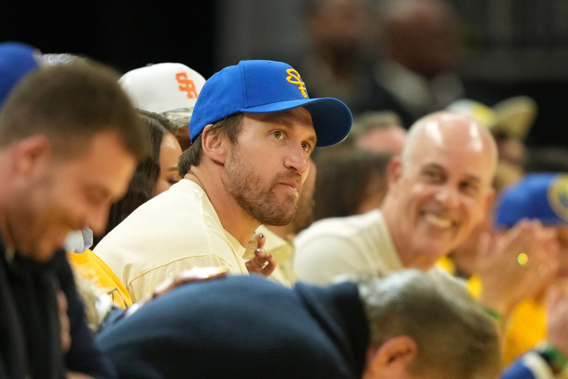 San Francisco 49ers running back Kyle Juszczyk (center) sits courtside during the third quarter of game three of first round between the Golden State Warriors and the Houston Rockets for the 2024 NBA Playoffs at Chase Center.