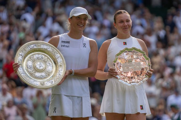 Iga Swiatek of Poland and  Amanda Anisimova of the United States pose with their trophies after the women’s singles final on day 13 at All England Lawn Tennis and Croquet Club.
