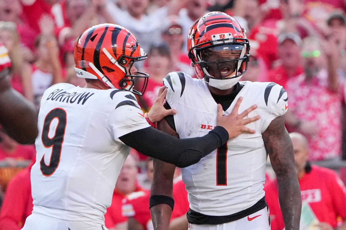 Cincinnati Bengals quarterback Joe Burrow (9) restrains wide receiver Ja'Marr Chase (1) after an altercation with officials during the second half of the game against the Kansas City Chiefs at GEHA Field at Arrowhead Stadium.