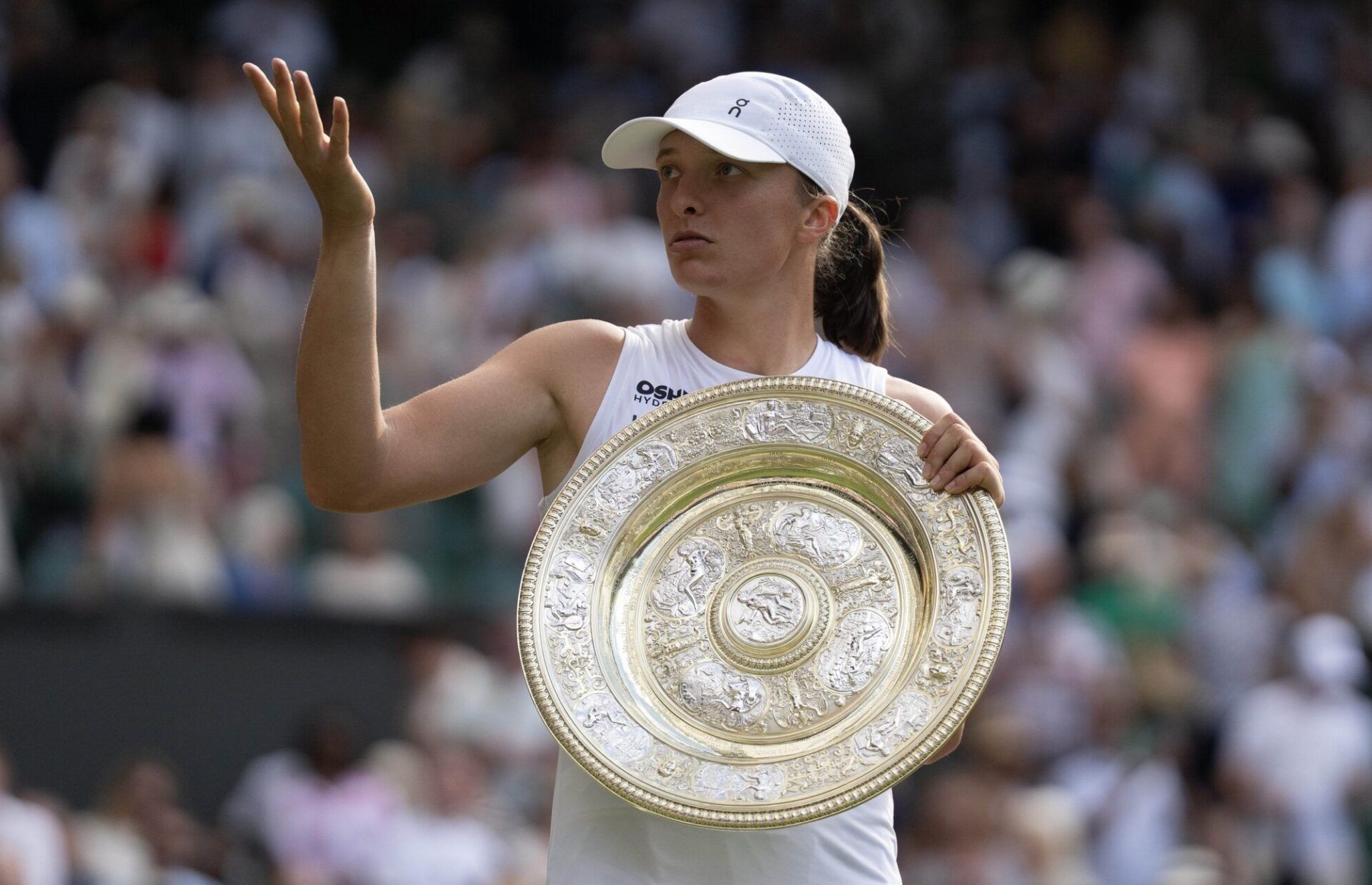 Iga Swiatek of Poland gestures to her box after winning the women’s final match against Amanda Anisimova of the United States on day 13 at All England Lawn Tennis and Croquet Club.