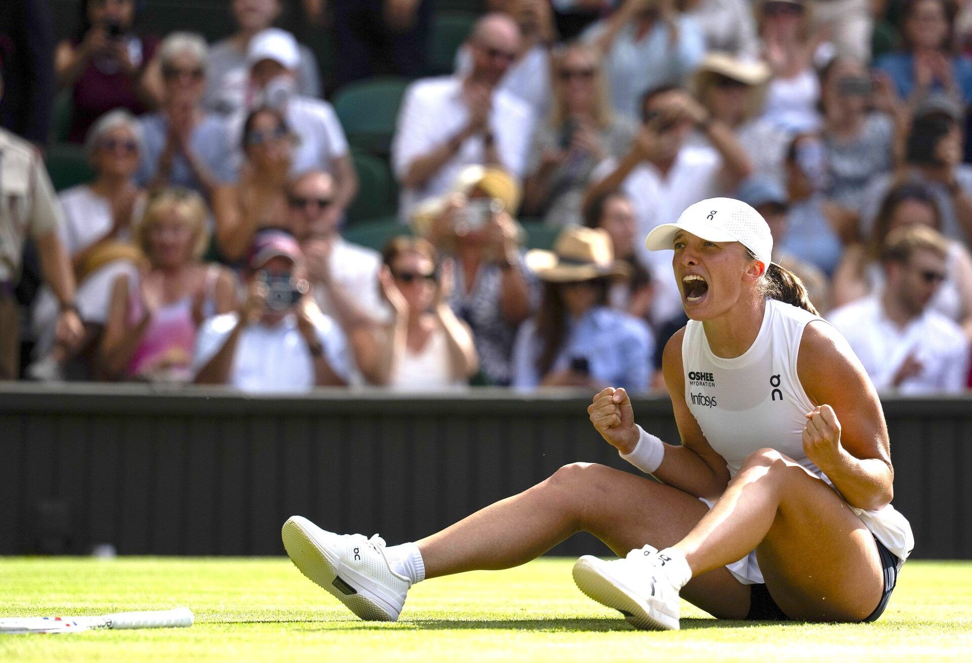 Iga Swiatek of Poland celebrates winning the women’s final match against Amanda Anisimova of the United States on day 13 at All England Lawn Tennis and Croquet Club.