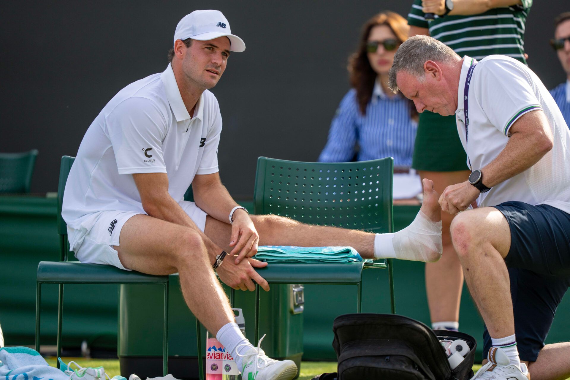 Tommy Paul of the United States receives treatment during a medical time out during his match against Sebastian Ofner of Austria on day four at the All England Lawn Tennis and Croquet Club.