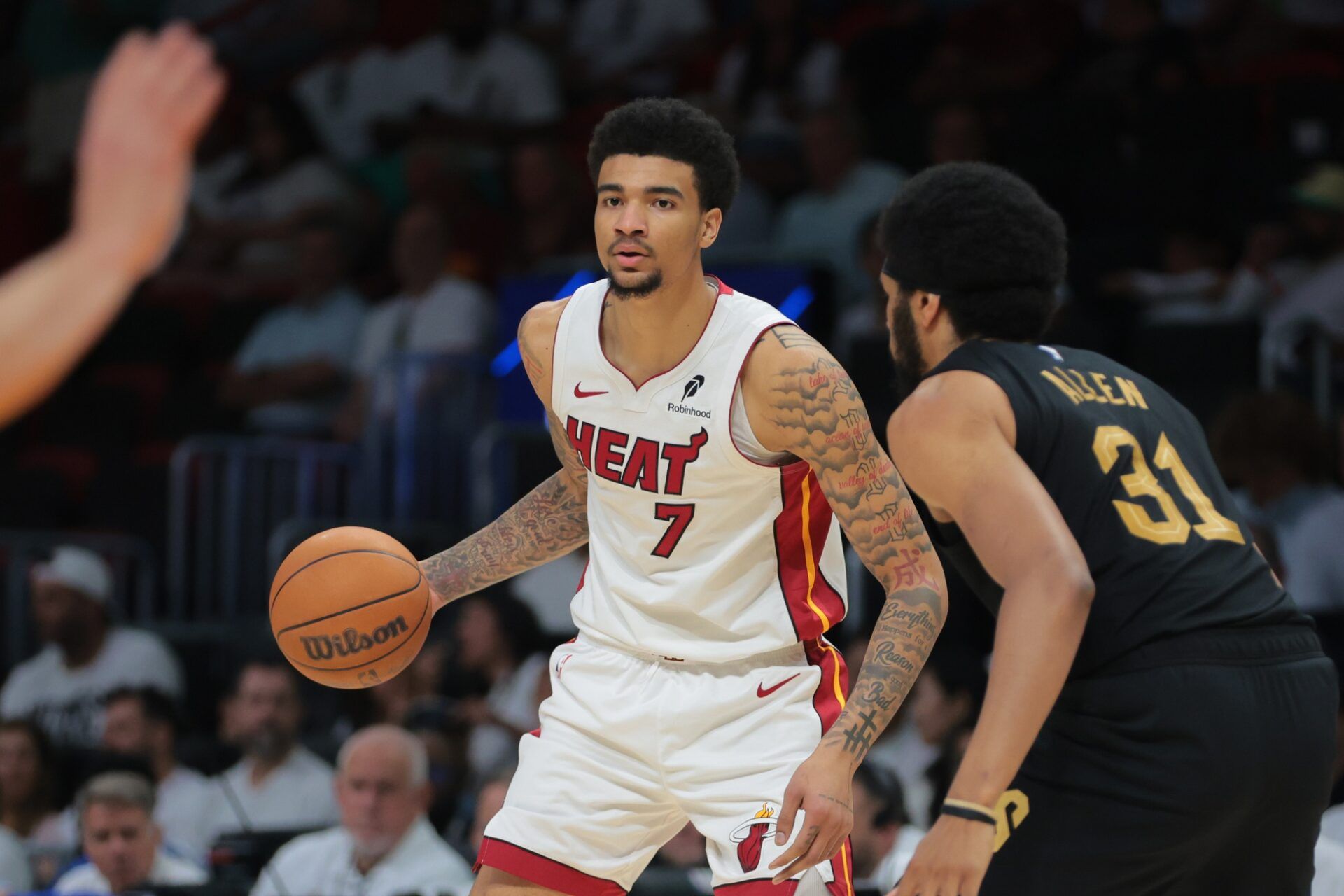 Miami Heat center Kel'el Ware (7) dribbles the basketball as Cleveland Cavaliers center Jarrett Allen (31) defends in the third quarter during game three for the first round of the 2025 NBA Playoffs at Kaseya Center.