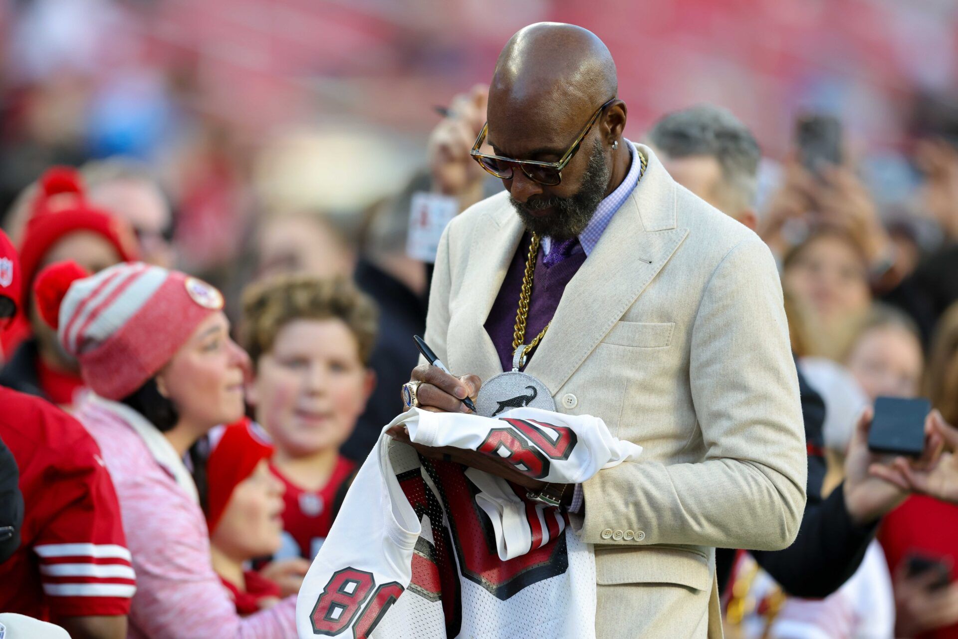 San Francisco 49ers hall of famer Jerry Rice signs autographs before the game against the Detroit Lions at Levi's Stadium.