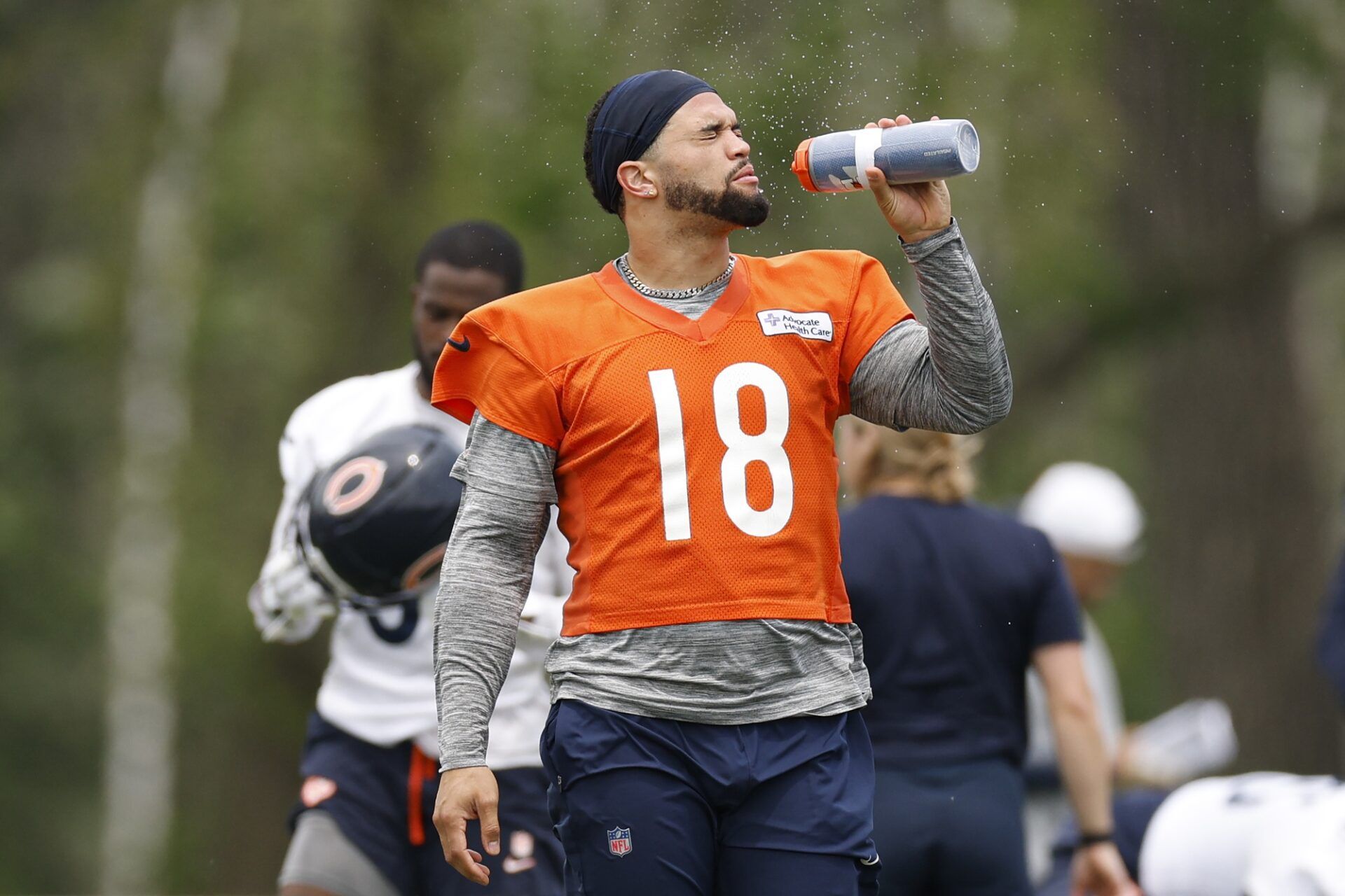 Chicago Bears quarterback Caleb Williams (18) cools off during minicamp at Halas Hall.