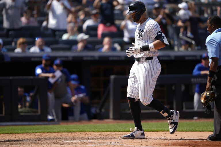 New York Yankees right fielder Aaron Judge (99) crosses the plate after hitting a two home run against the Chicago Cubs during the ninth inning at Yankee Stadium.