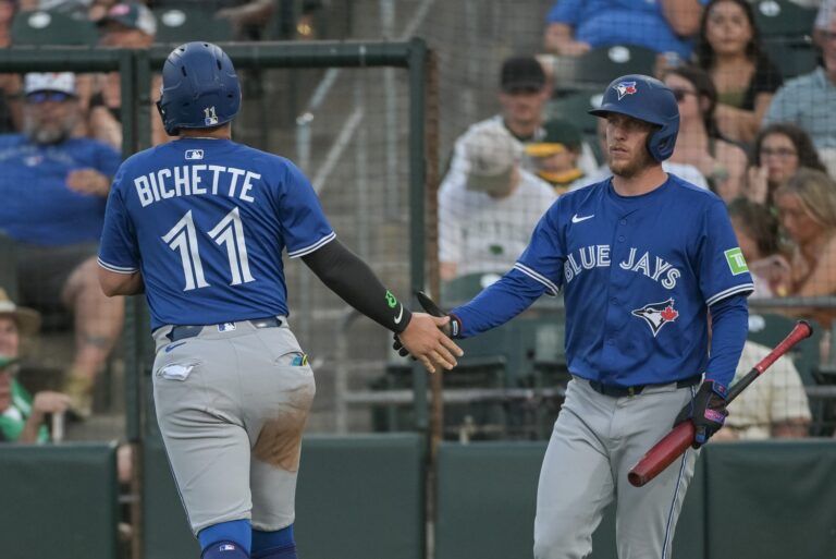 Toronto Blue Jays shortstop Bo Bichette (11) celebrates with outfielder Myles Straw (3) after scoring against the Athletics during the fourth inning at Sutter Health Park.