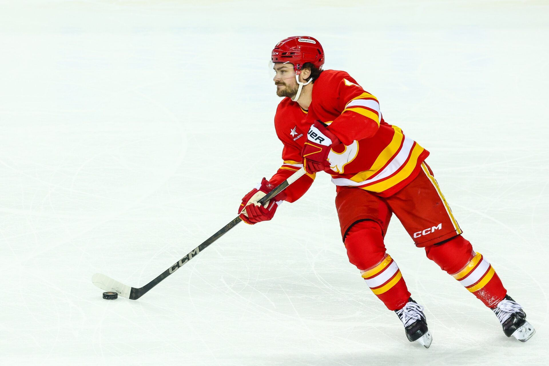 Calgary Flames defenseman Rasmus Andersson (4) skates with the puck against the San Jose Sharks during the first period at Scotiabank Saddledome.