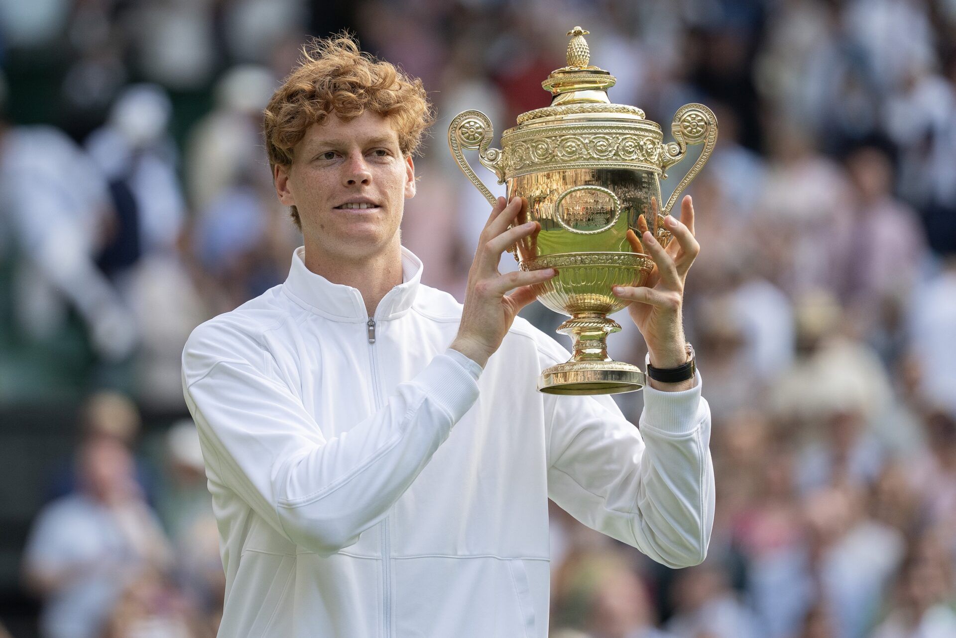 Jannik Sinner of Italy poses with the trophy after winning the menÕs singles final match against Carlos Alcaraz of Spain on day 14 at All England Lawn Tennis and Croquet Club.