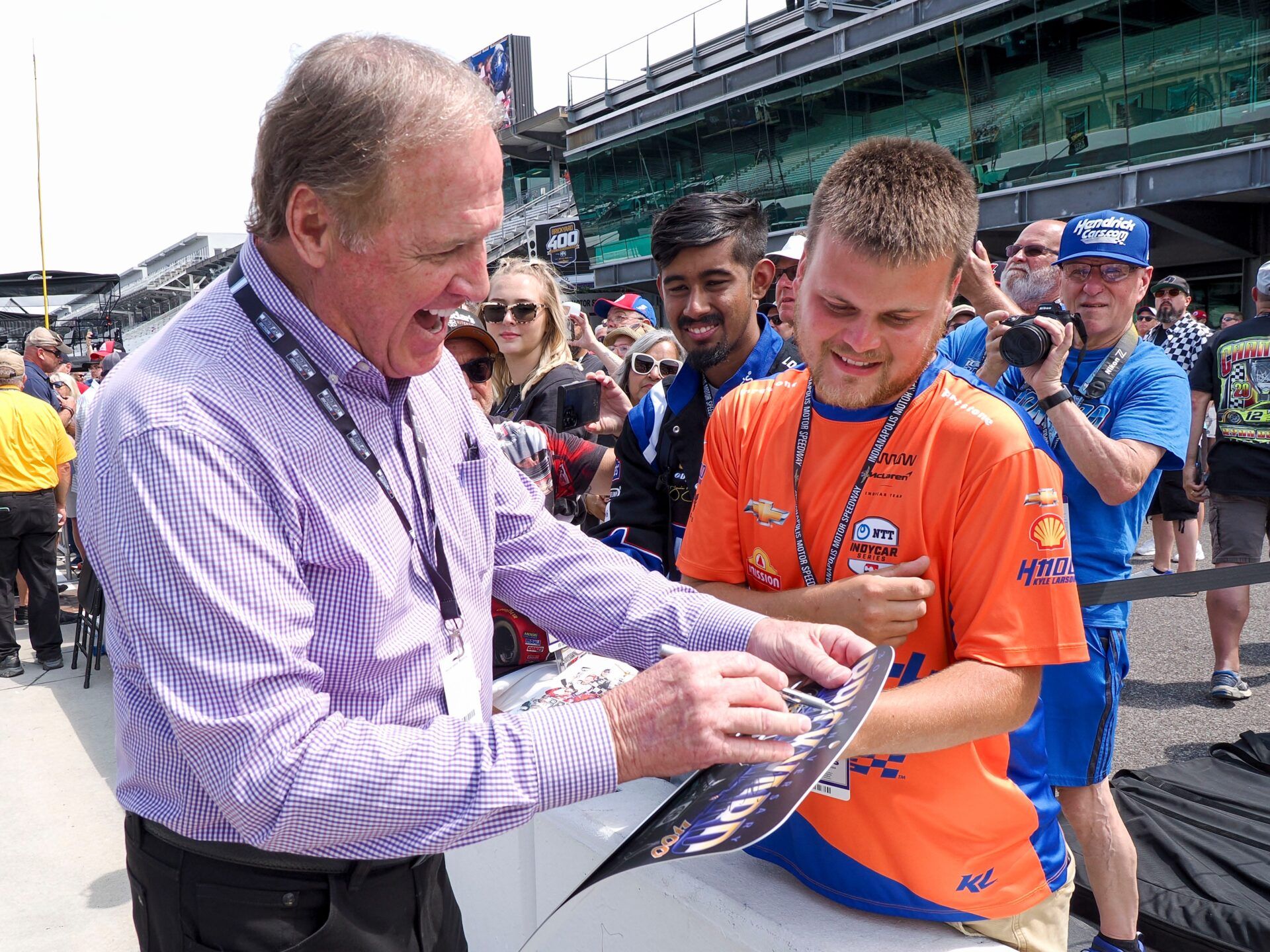 Former NASCAR driver Rusty Wallace signs an autograph ahead of the Brickyard 400, Sunday, July 21, 2024, at Indianapolis Motor Speedway.