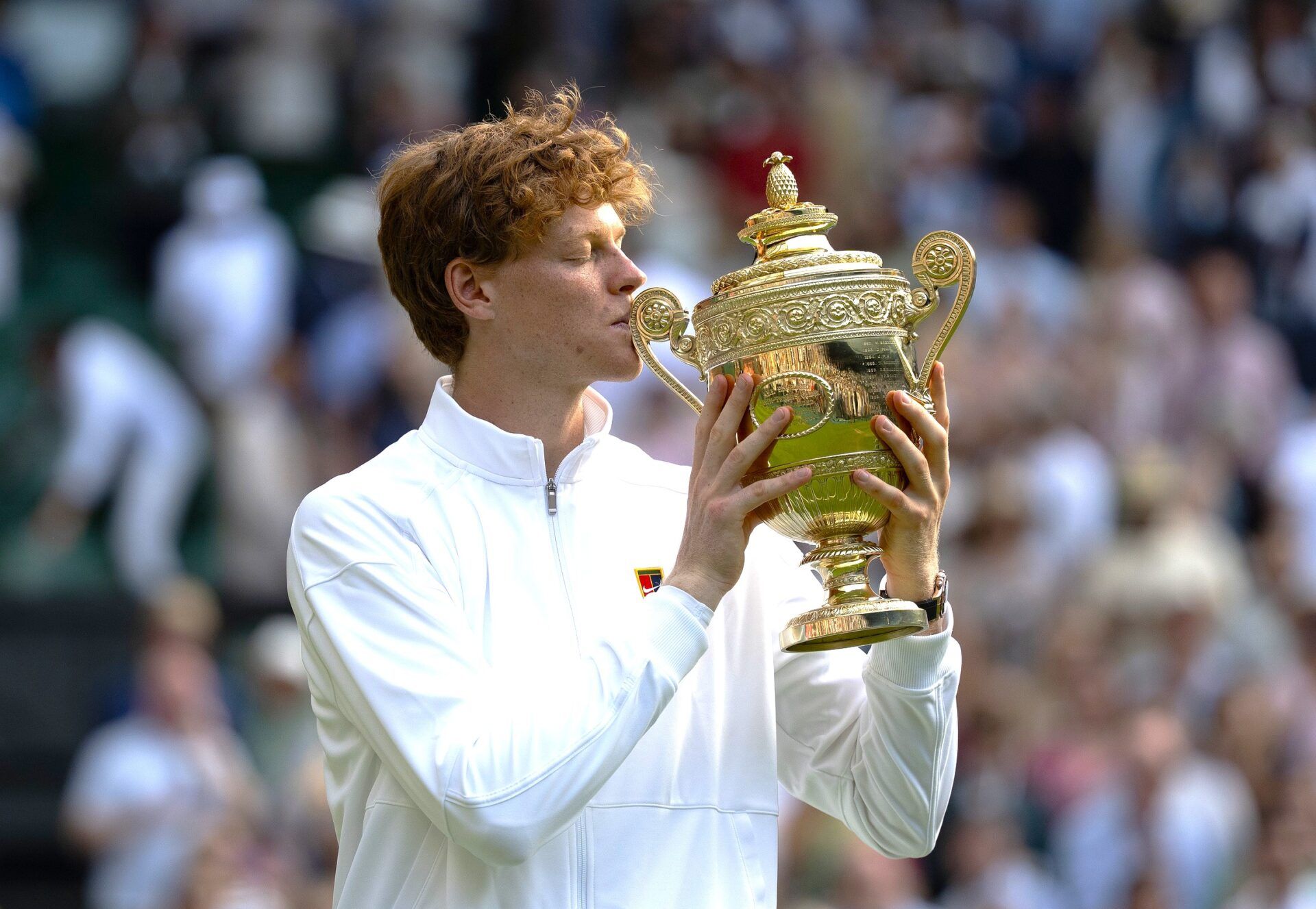 Jannik Sinner of Italy kisses the trophy after winning the menÕs singles final match against Carlos Alcaraz of Spain on day 14 at All England Lawn Tennis and Croquet Club.