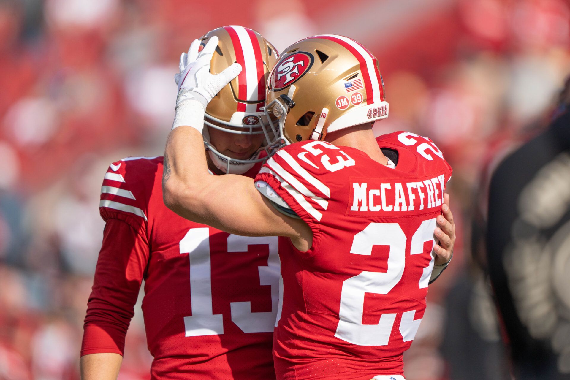 San Francisco 49ers running back Christian McCaffrey (23) embraces quarterback Brock Purdy (13) during warmups before the start of the first quarter against the Washington Commanders at Levi's Stadium.