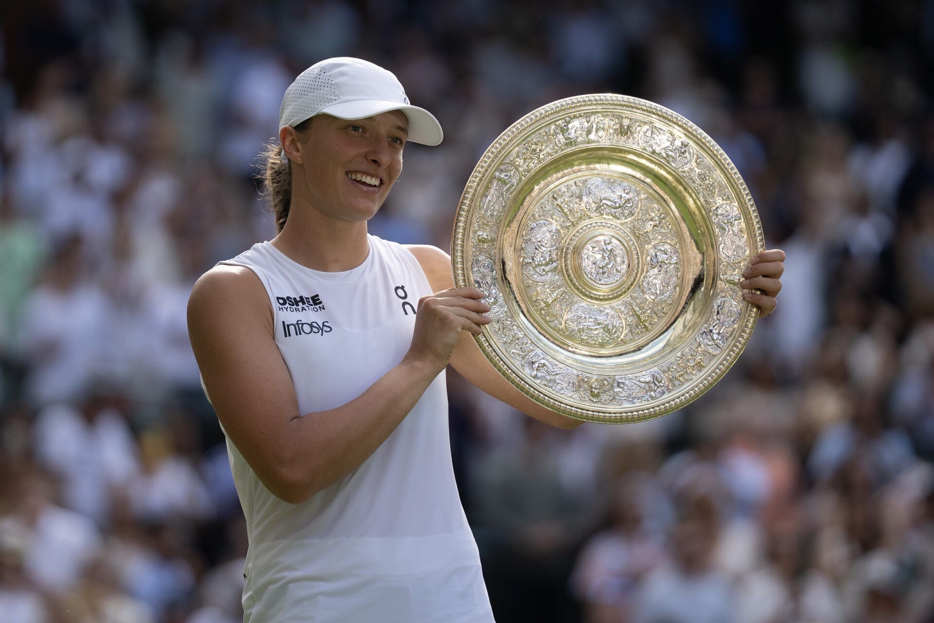 Iga Swiatek of Poland poses with the trophy after winning the women’s final match against Amanda Anisimova of the United States on day 13 at All England Lawn Tennis and Croquet Club.