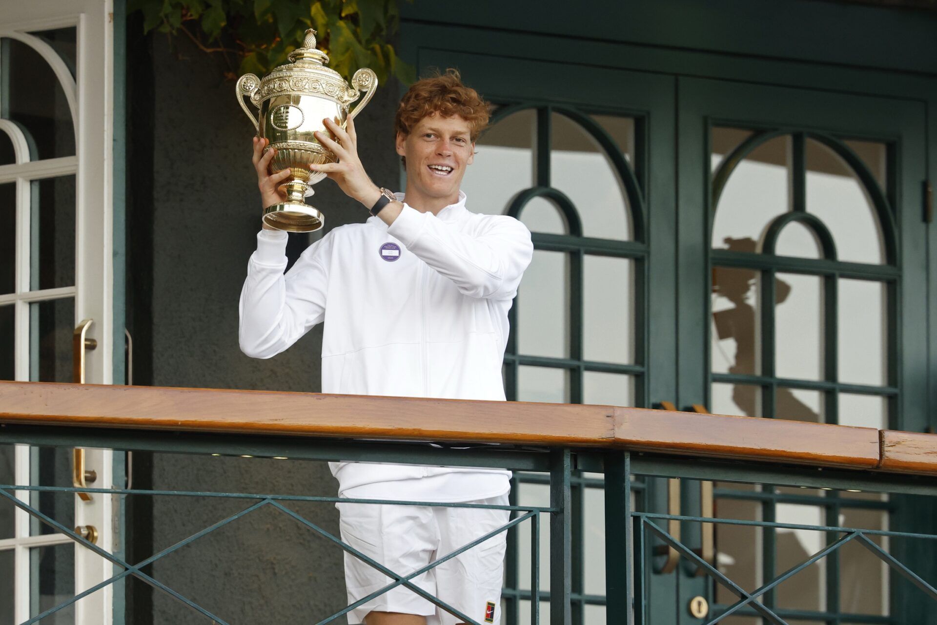 Jannik Sinner (ITA) stands on the South West Hall balcony holding the gentlemen's singles champion trophy, after his match against Carlos Alcaraz (ESP)(not pictured) in the gentlemen's' singles final of The Championships Wimbledon 2025 at All England Lawn Tennis and Croquet Club.