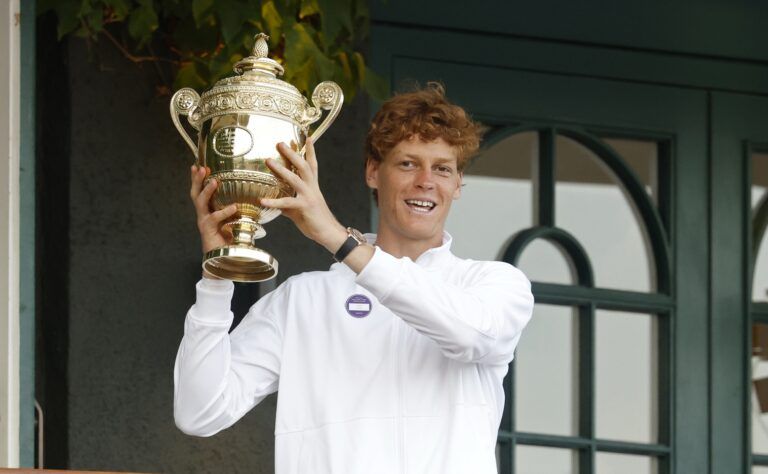 Jannik Sinner (ITA) stands on the South West Hall balcony holding the gentlemen's singles champion trophy, after his match against Carlos Alcaraz (ESP)(not pictured) in the gentlemen's' singles final of The Championships Wimbledon 2025 at All England Lawn Tennis and Croquet Club.
