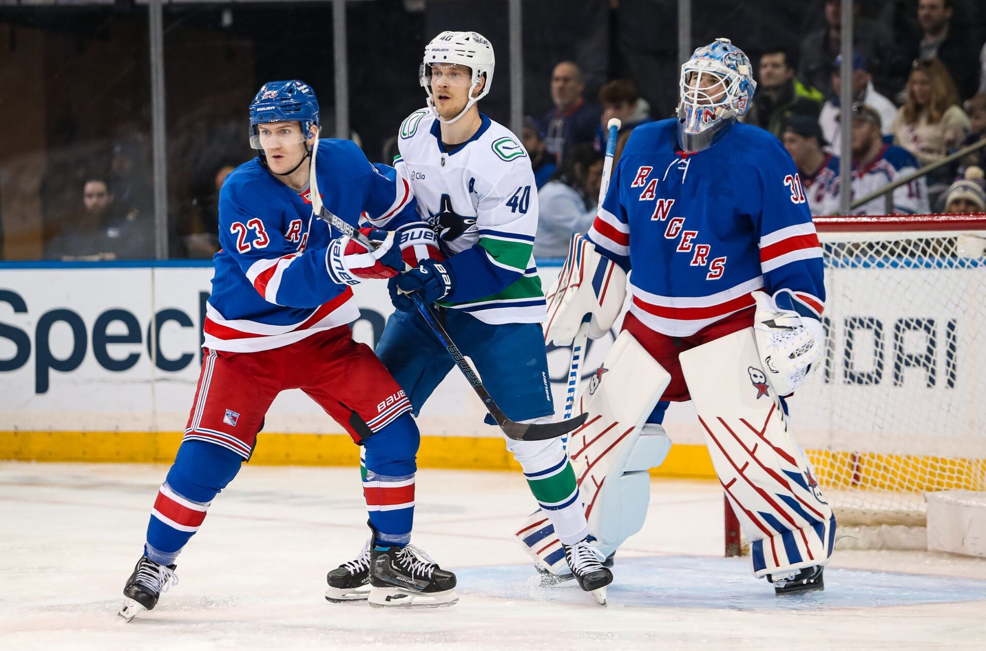 New York Rangers defenseman Adam Fox (23) and Vancouver Canucks center Elias Pettersson (40) battle for position in front of New York Rangers goalie Igor Shesterkin (31) during the second period at Madison Square Garden.