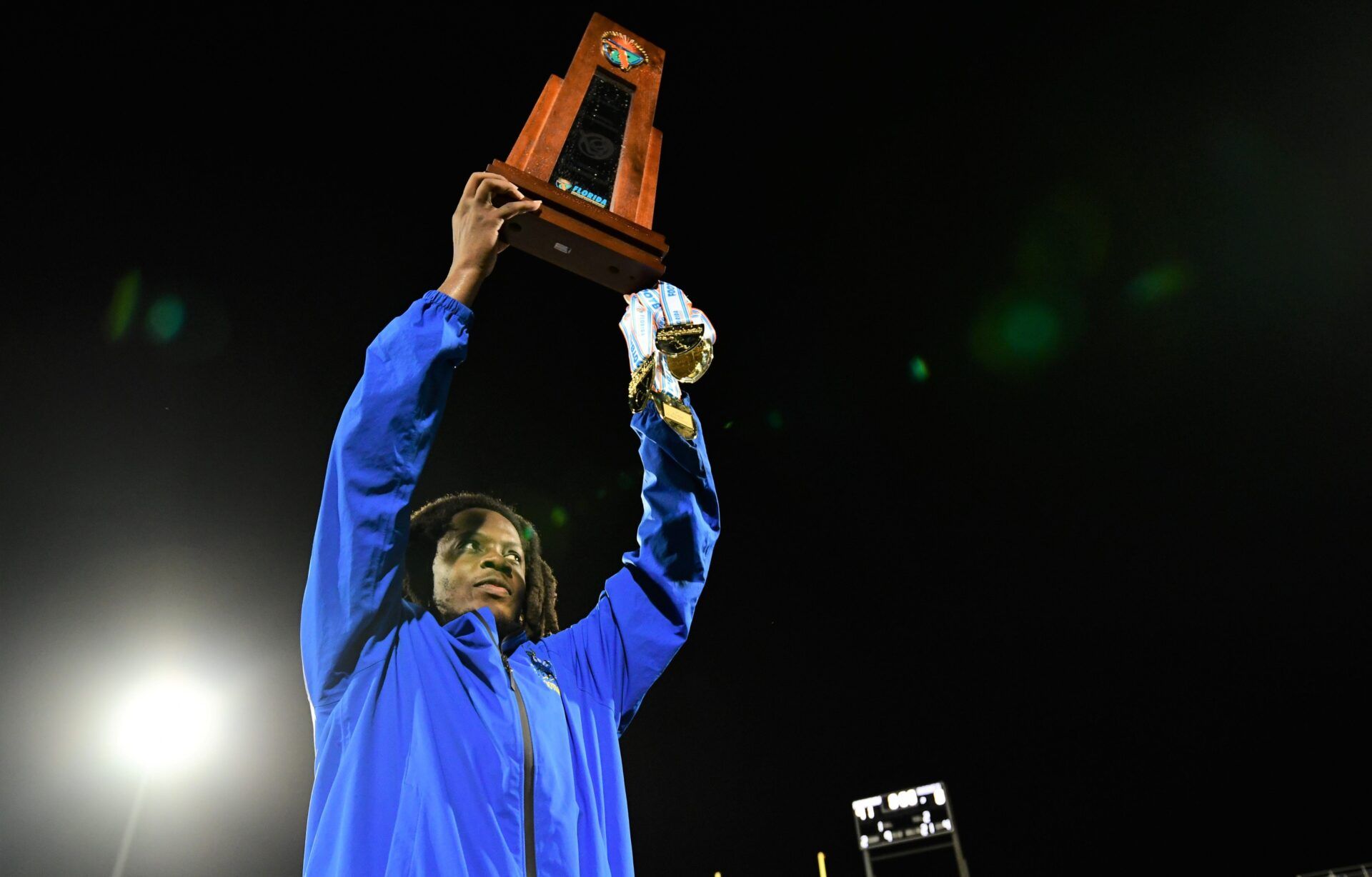 Miami Northwestern's Teddy Bridgewater raises the state trophy following the team's win over Raines in the Class 3A championship on Dec. 14, 2024.