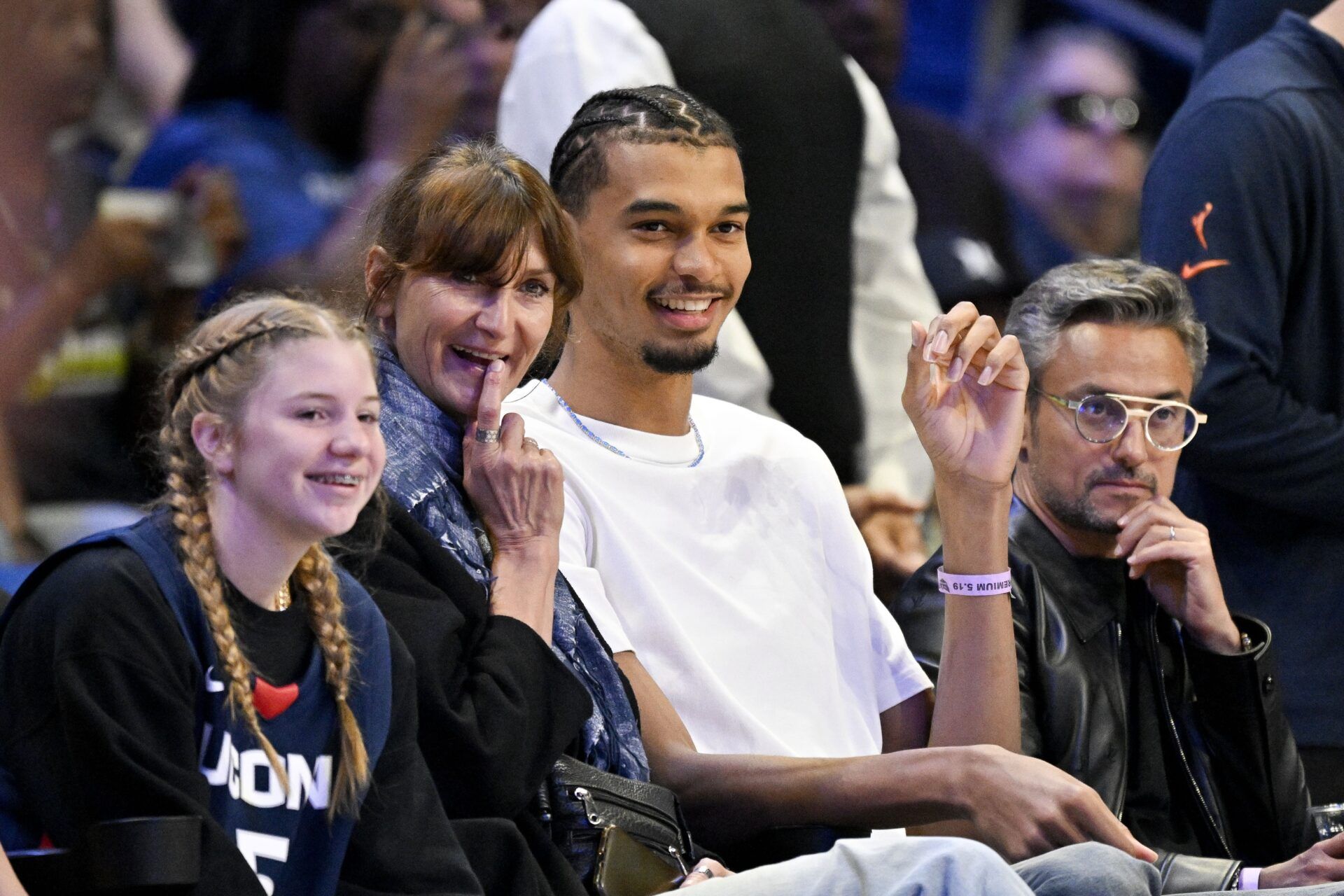 San Antonio Spurs forward Victor Wembanyama and his mother Elodie de Fautereau watch the game between the Dallas Wings and the Seattle Storm during the first half at College Park Center.