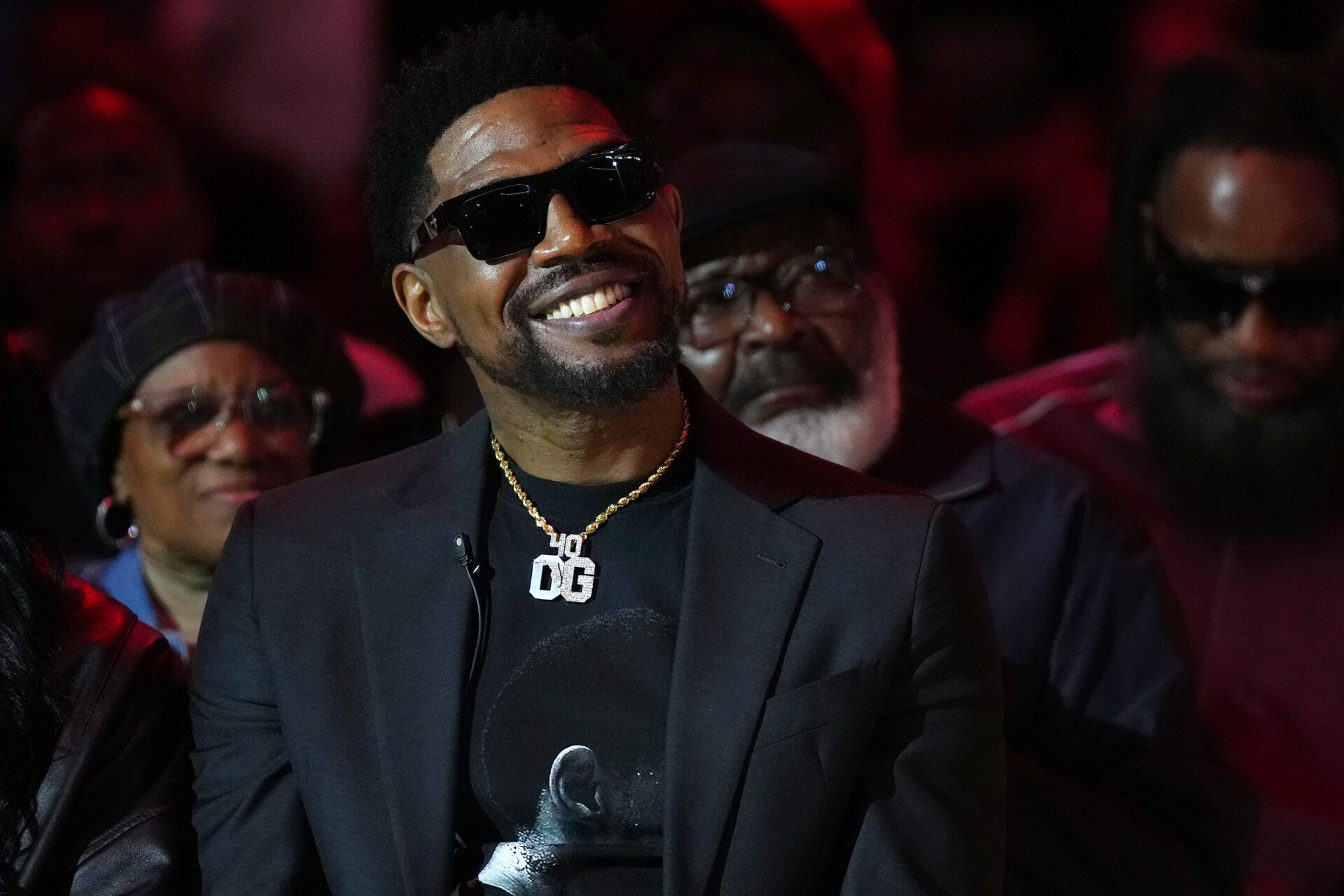 Former Miami Heat player Udonis Haslem sits on the court for his jersey retirement ceremony during halftime of the game between the Miami Heat and the Atlanta Hawks Kaseya Center.