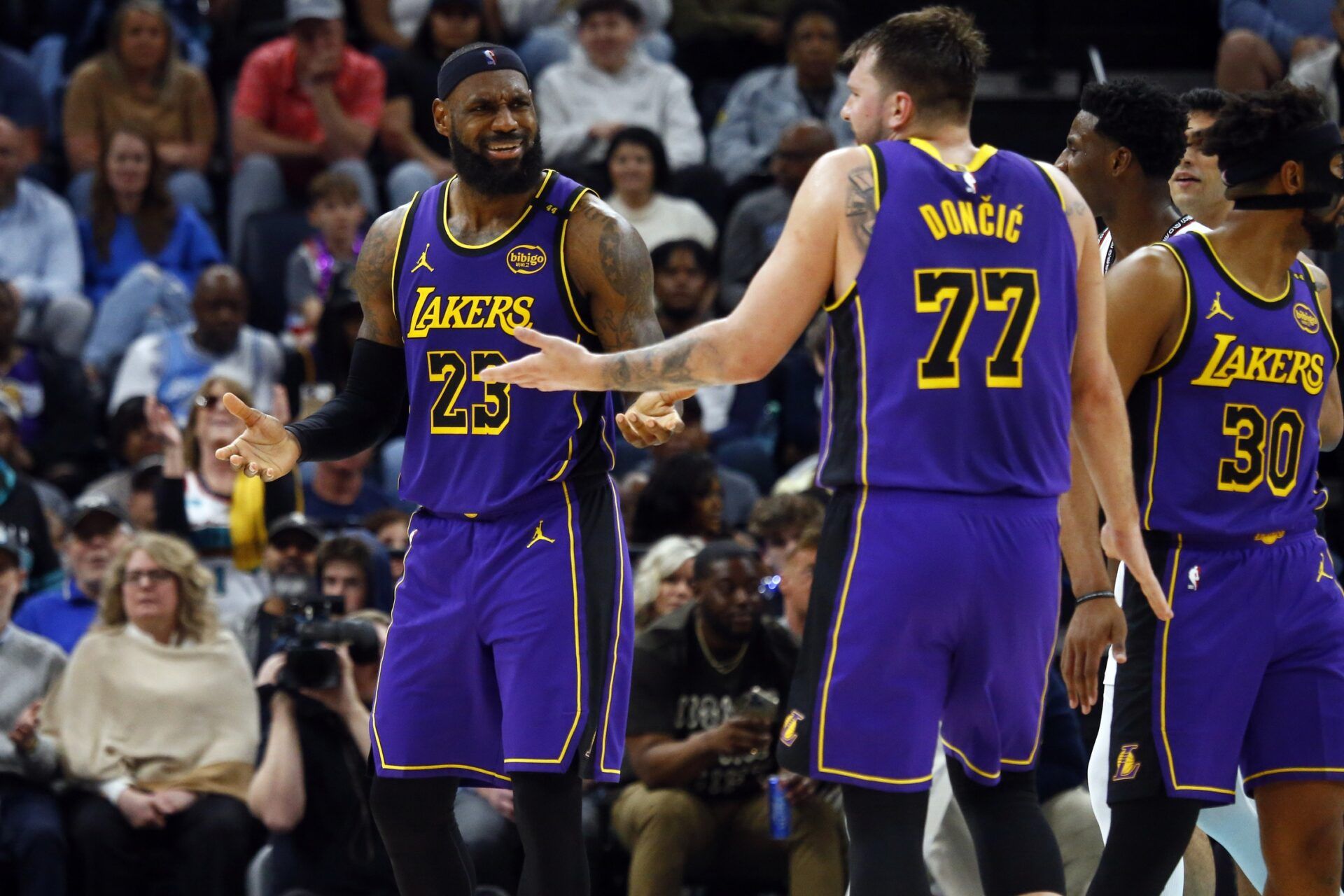 Los Angeles Lakers forward LeBron James (23) and guard Luka Doncic (77) react during the third quarter against the Memphis Grizzlies at FedExForum.