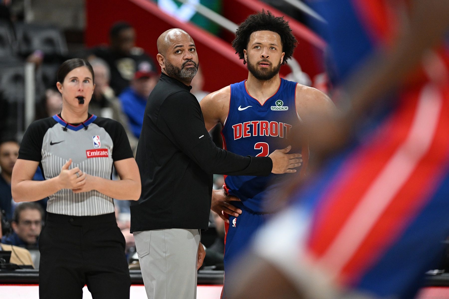 Detroit Pistons head coach J.B. Bickerstaff talks with  guard Cade Cunningham (2) during a Charlotte Hornets foul shot in the third quarter at Little Caesars Arena.