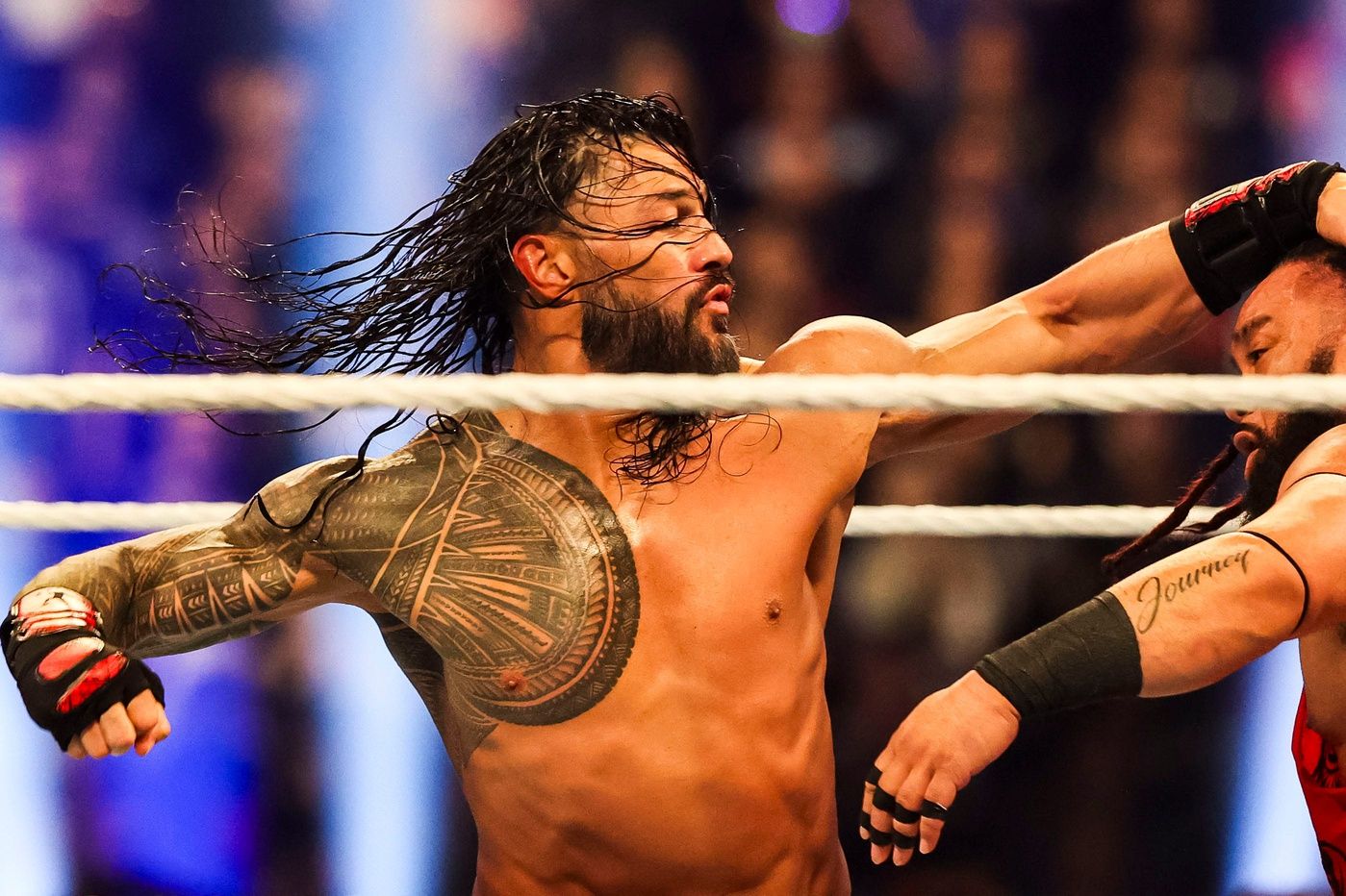 Roman Reigns throws a punch at Jacob Fatu (right) on Saturday, Feb. 1, 2025, during the WWE Royal Rumble at Lucas Oil Stadium in Indianapolis.