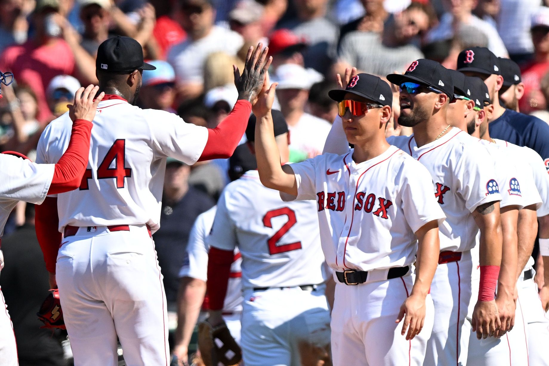 Boston Red Sox pitcher Aroldis Chapman (44) high-fives outfielder Masataka Yoshida (7) after a game against the Tampa Bay Rays during the ninth inning  at Fenway Park.