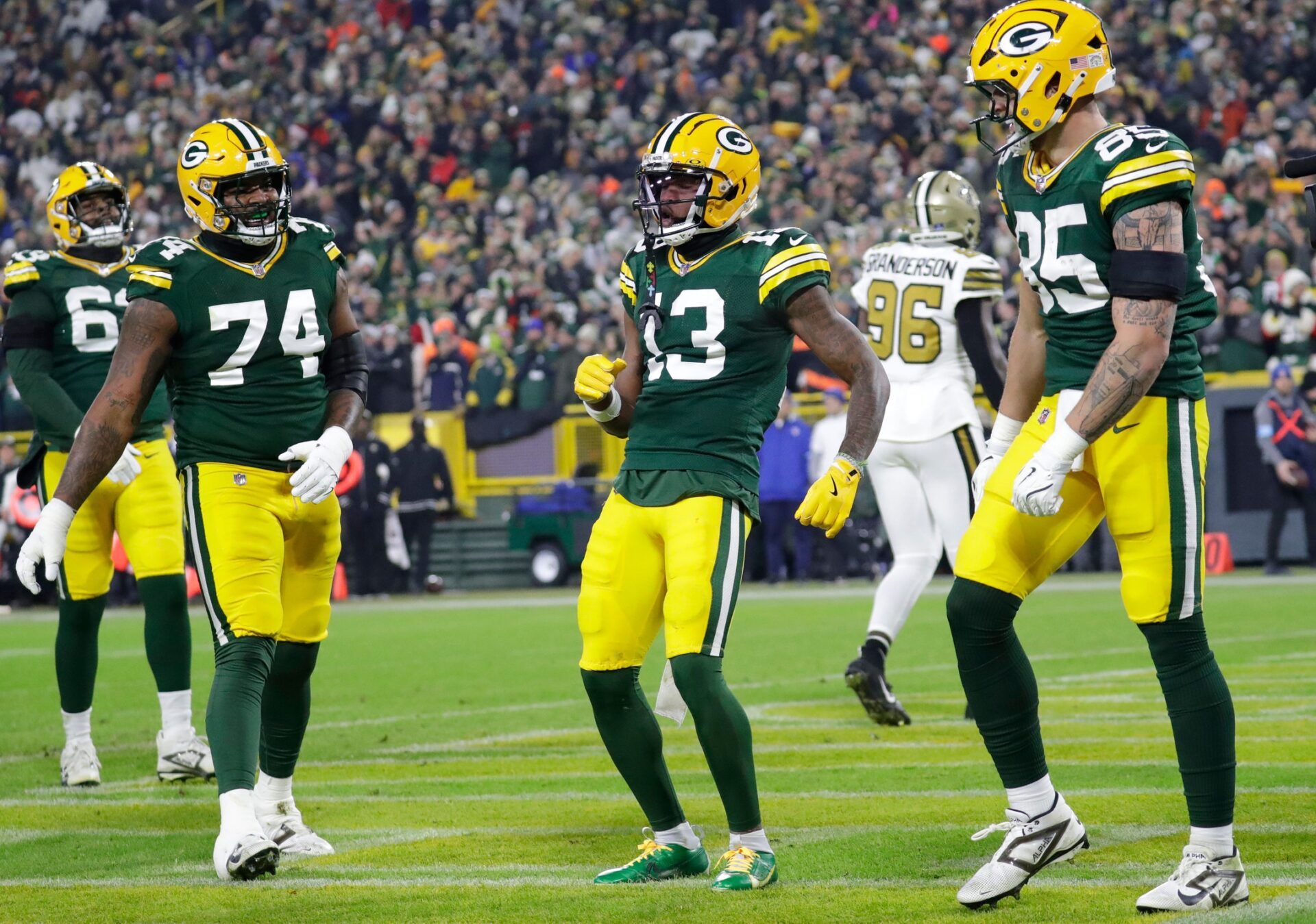 Green Bay Packers wide receiver Dontayvion Wicks (13) celebrates scoring a touchdown against the New Orleans Saints during their football game Monday, December 23, 2024, at Lambeau Field in Green Bay, Wisconsin.