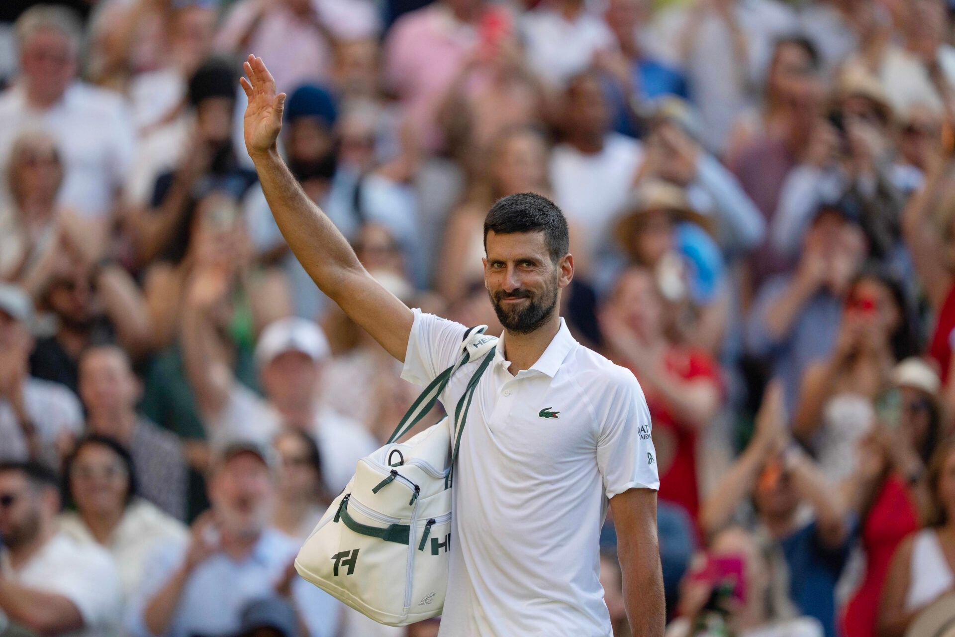 Novak Djokovic of Serbia leaves the court after losing his match to Jannik Sinner of Italy after their match on day 12 at All England Lawn Tennis and Croquet Club.