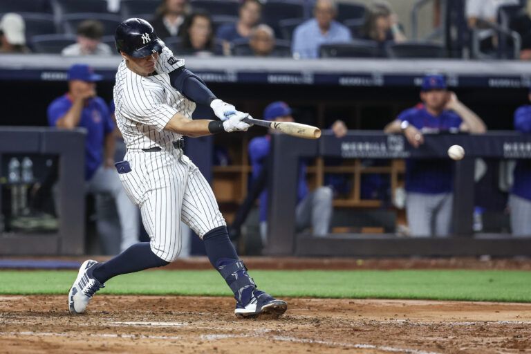 New York Yankees shortstop Anthony Volpe (11) hits an RBI double in the sixth inning against the Chicago Cubs at Yankee Stadium.