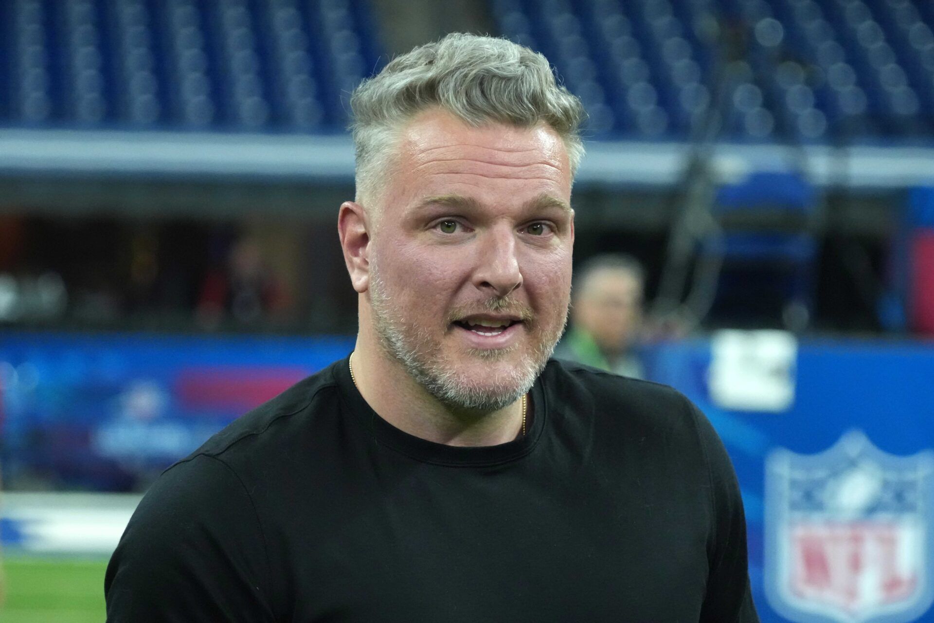 Pat McAfee watches during workouts at the 2025 NFL Scouting Combine at Lucas Oil Stadium.