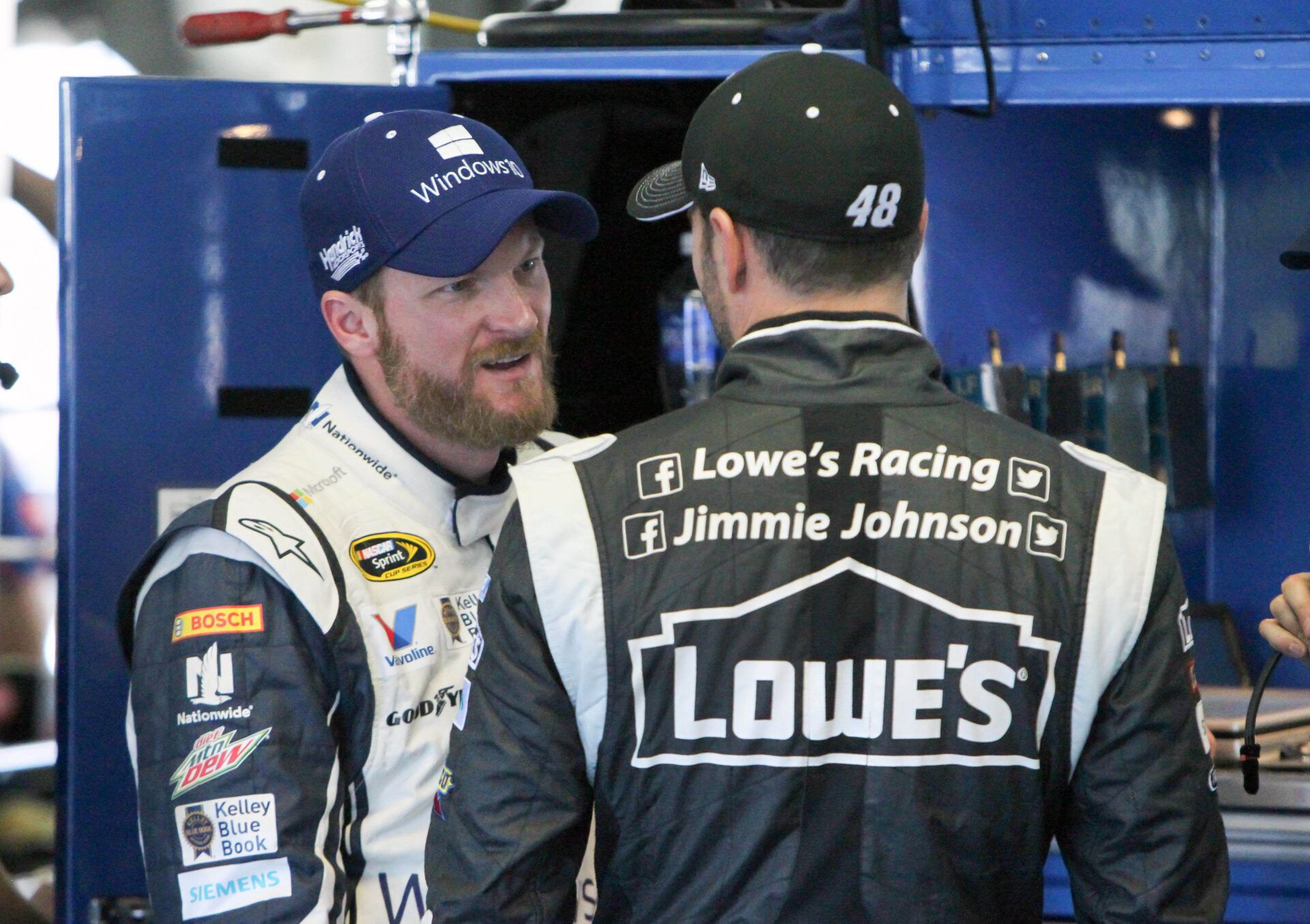 NASCAR Sprint Cup Series driver Dale Earnhardt Jr (left) talks to driver Jimmie Johnson (right) during practice for the Windows 10 400 at Pocono Raceway.