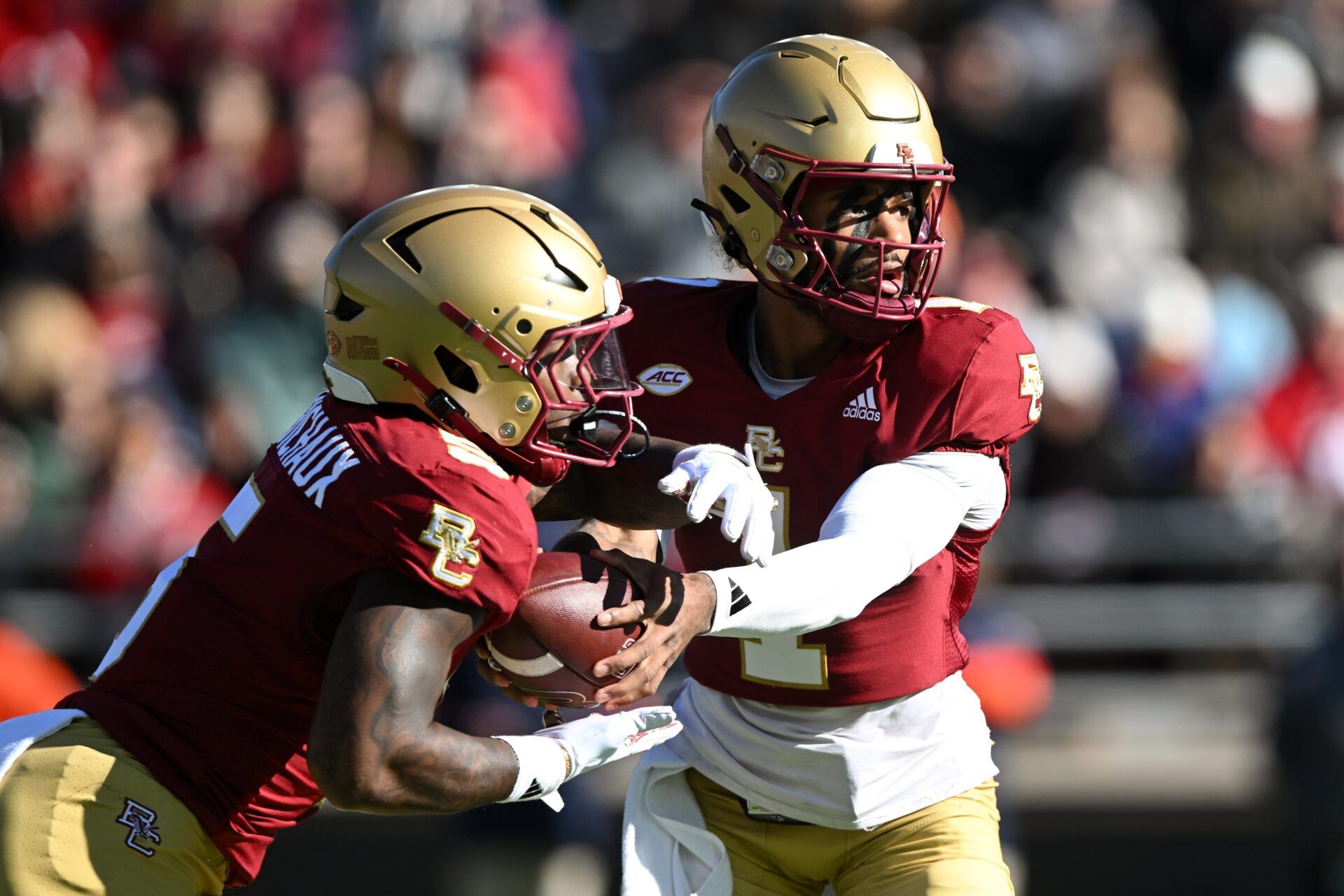 Boston College Eagles quarterback Thomas Castellanos (1) hands the ball off to unning back Kye Robichaux (5) during the first half at Alumni Stadium.