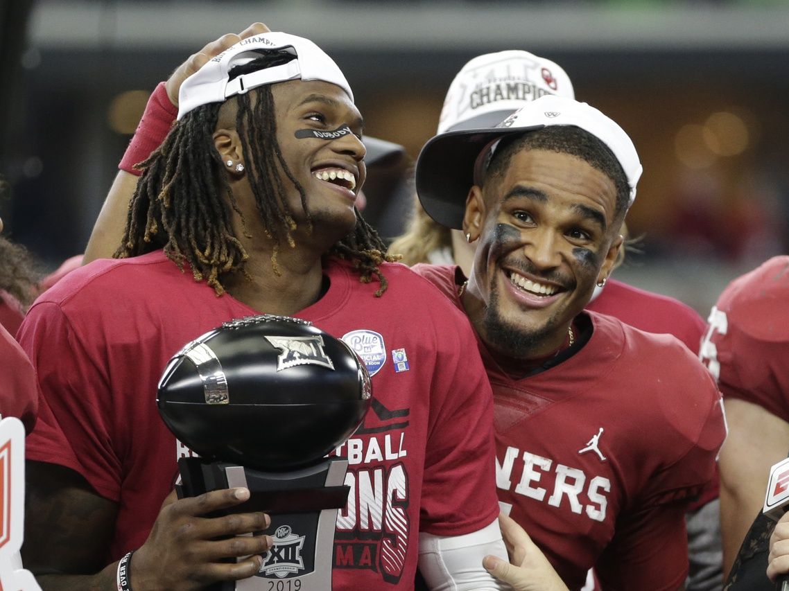 Oklahoma Sooners wide receiver CeeDee Lamb (2) is congratulated by quarterback Jalen Hurts (1) after winning the most valuable player award in the 2019 Big 12 Championship Game against the Baylor Bears at AT&T Stadium.