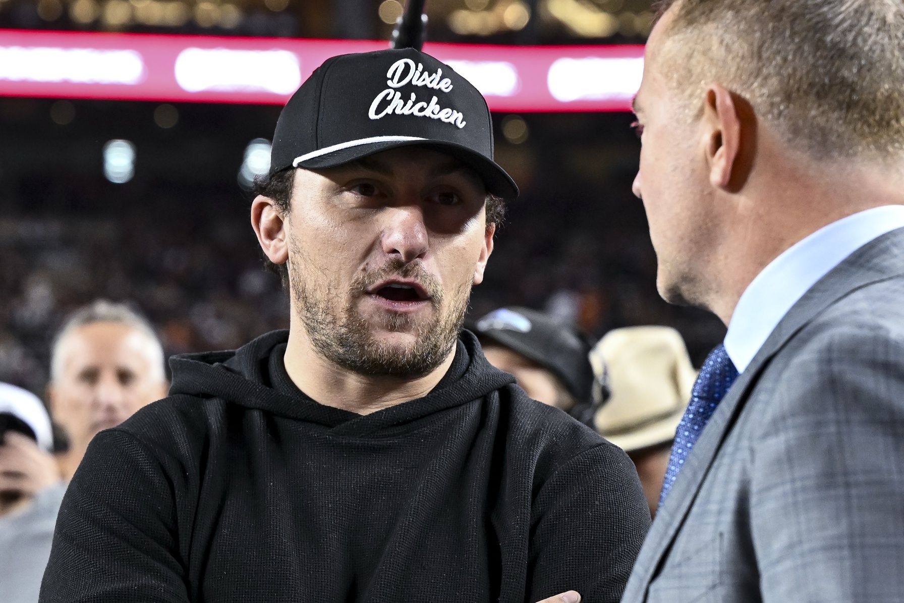 Former Texas A&M and Cleveland Browns quarterback Johnny Manziel speaks with ESPN's College GameDay analyst Kirk Herbstreit prior to the game against the Texas Longhorns. The Longhorns defeated the Aggies 17-7 at Kyle Field.