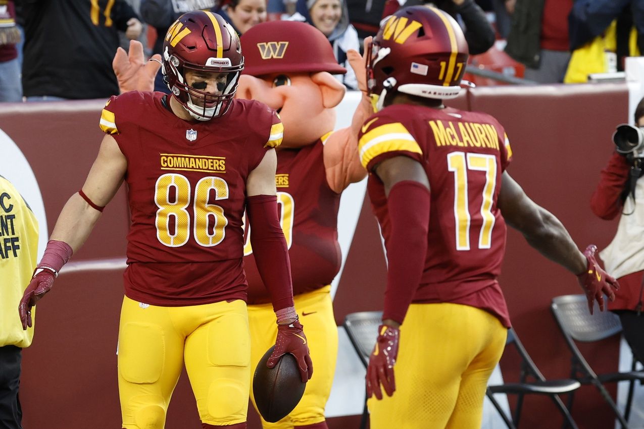 Washington Commanders tight end Zach Ertz (86) celebrates with Commanders wide receiver Terry McLaurin (17) after catching a touchdown pass against the Dallas Cowboys at Northwest Stadium.