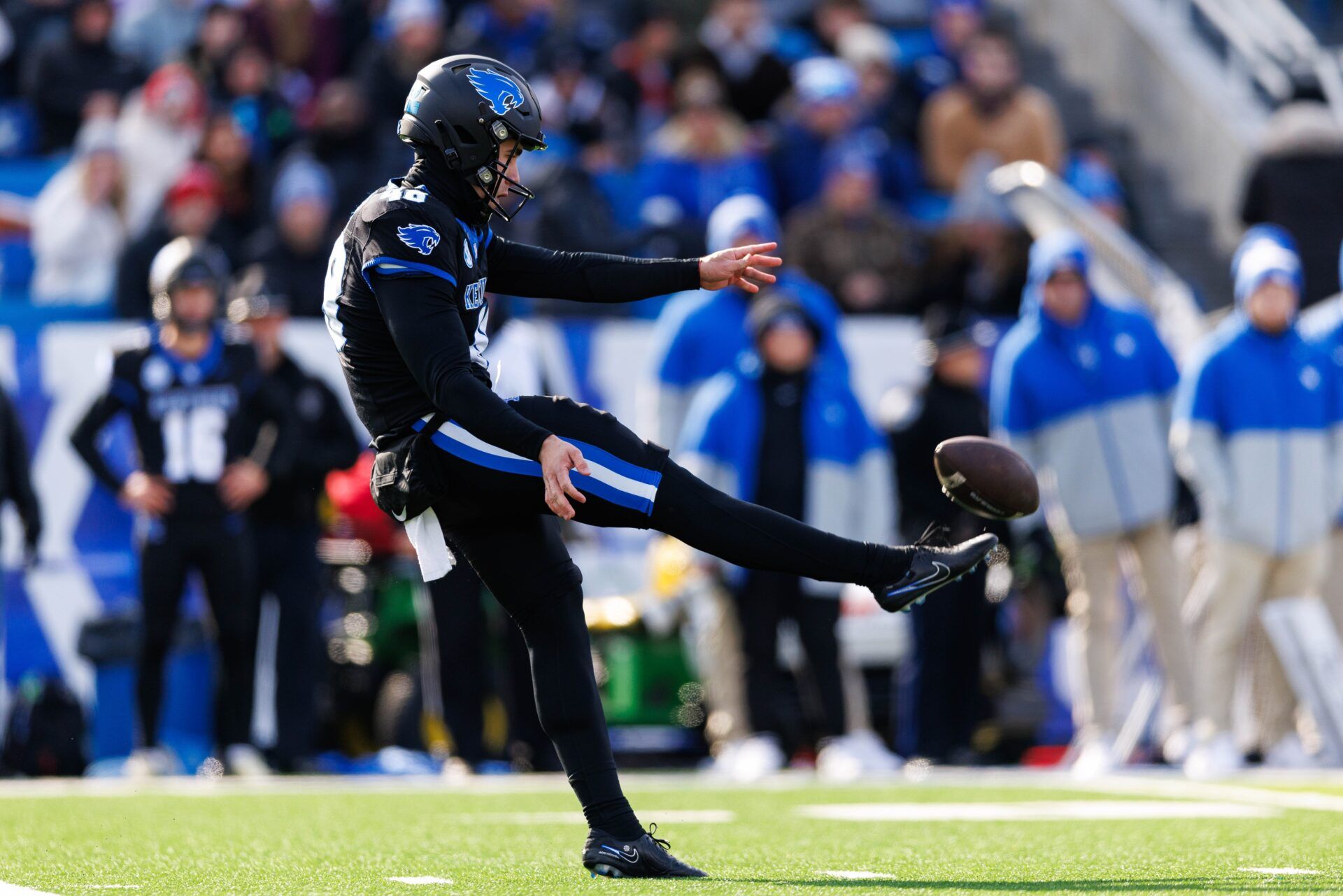 Kentucky Wildcats punter Aidan Laros (48) punts the ball during the first quarter against the Louisville Cardinals at Kroger Field.
