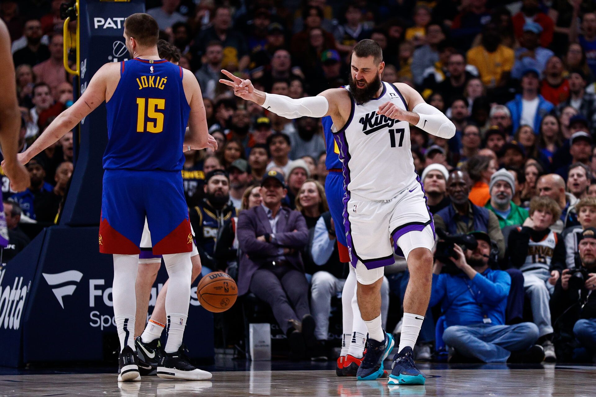 Sacramento Kings center Jonas Valanciunas (17) reacts after a play as Denver Nuggets center Nikola Jokic (15) looks on in the second quarter at Ball Arena.