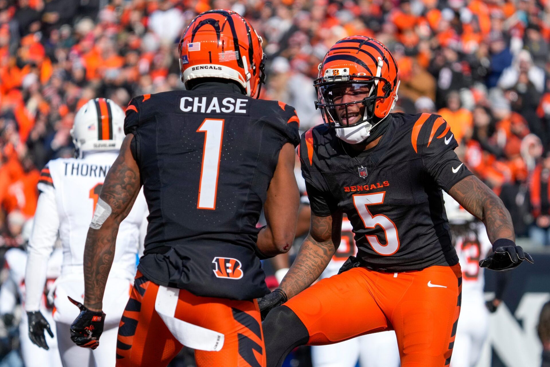 Cincinnati Bengals wide receiver Ja'Marr Chase (1) and wide receiver Tee Higgins (5) celebrate a Higgins touchdown reception in the first quarter of the NFL Week 16 game between the Cincinnati Bengals and the Cleveland Browns at Paycor Stadium in downtown Cincinnati on Sunday, Dec. 22, 2024. The Bengals led 17-0 at halftime.