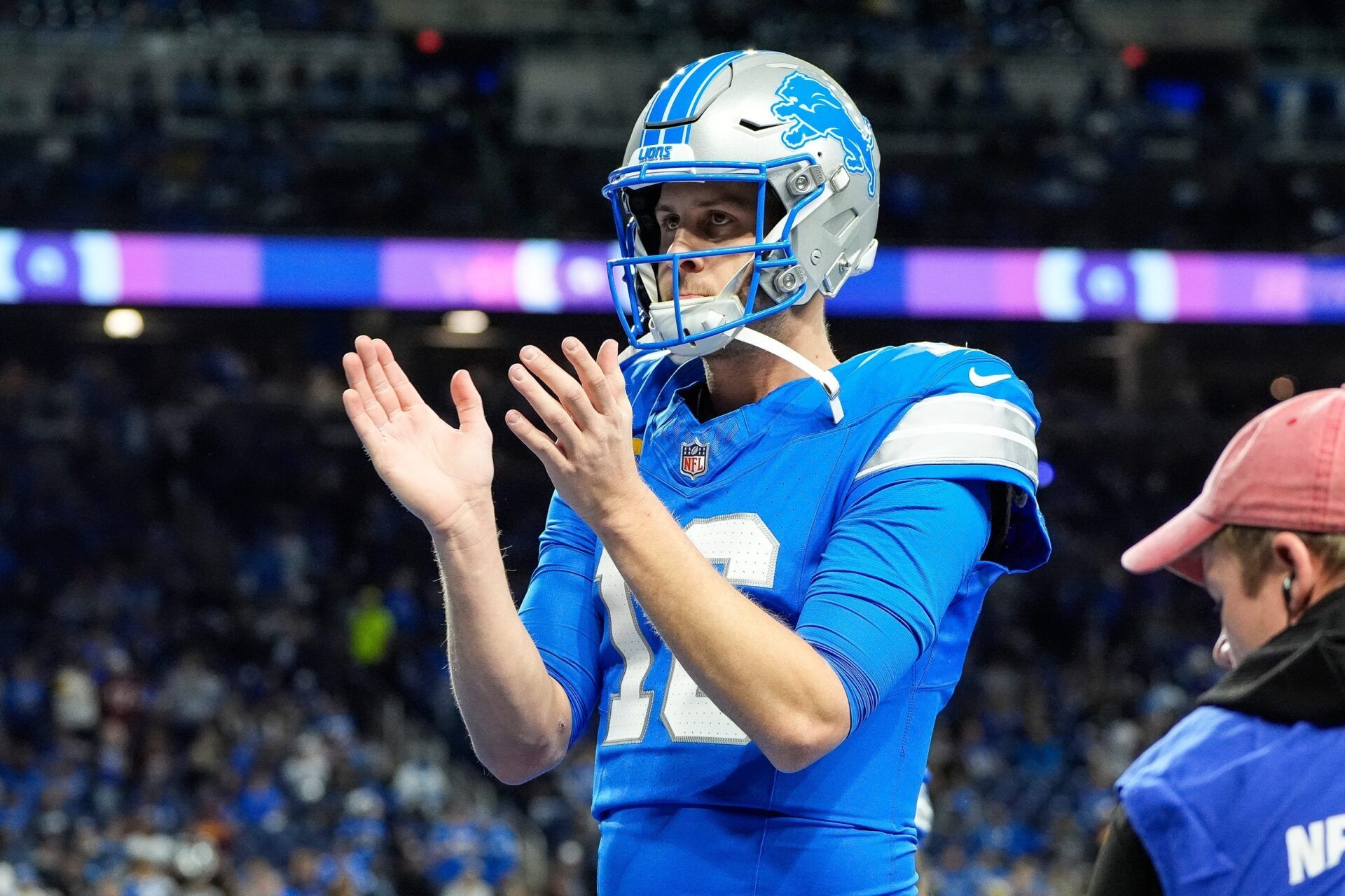 Detroit Lions quarterback Jared Goff (16) applauds for teammates art warm up before the NFC divisional round between Detroit Lions and Washington Commanders at Ford Field in Detroit on Saturday, Jan. 18, 2025.