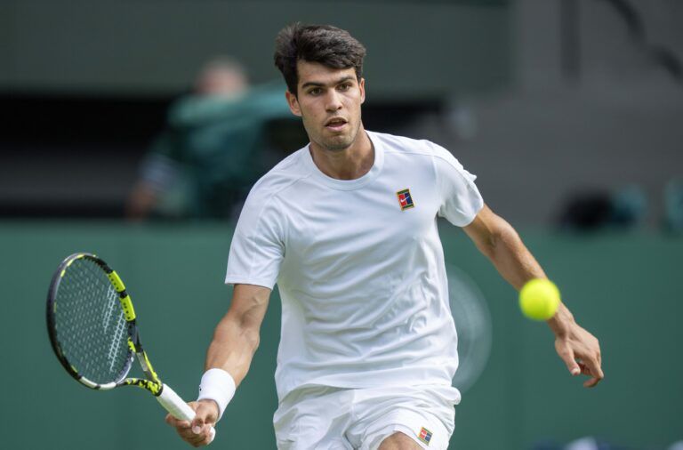 Carlos Alcaraz of Spain returns a shot during the menÕs singles final match against Jannik Sinner of Italy on day 14 at All England Lawn Tennis and Croquet Club.