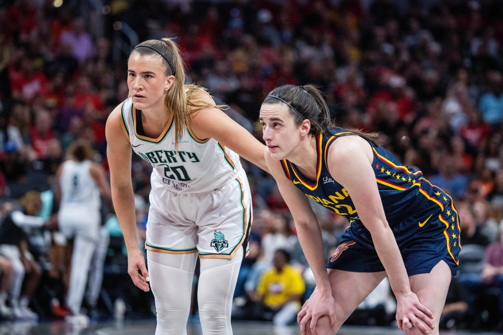 New York Liberty guard Sabrina Ionescu (20) and Indiana Fever guard Caitlin Clark (22)  in the second half at Gainbridge Fieldhouse.