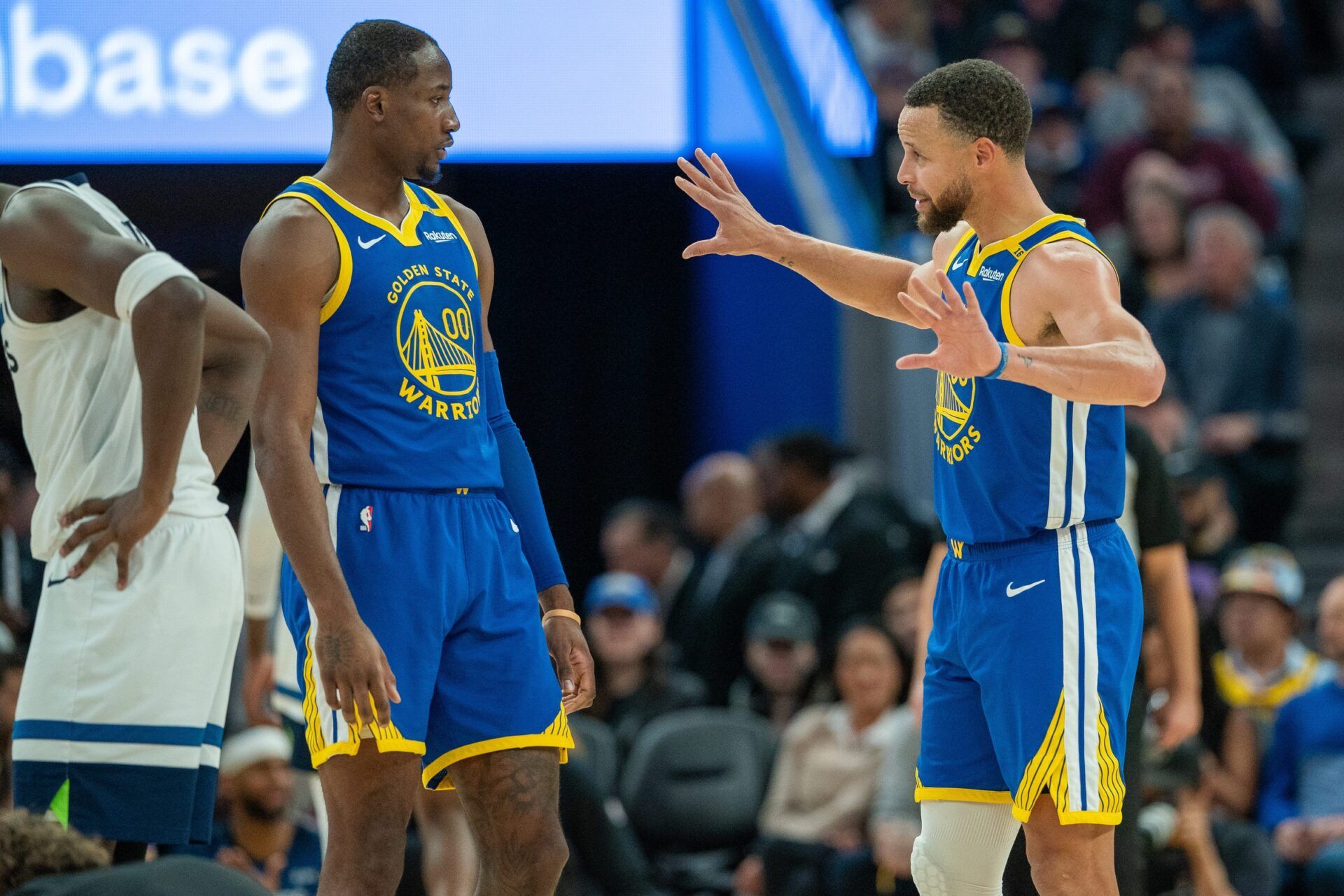 Golden State Warriors guard Stephen Curry (30) speaks with forward Jonathan Kuminga (00) during a time out against the Minnesota Timberwolves during the fourth quarter at Chase Center.